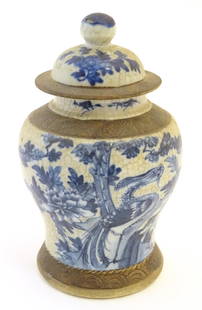 A Chinese blue and white ginger jar with a crackle glaze, the body decorated with a bird in a tree,: A Chinese blue and white ginger jar with a crackle glaze, the body decorated with a bird in a tree, with incised banded borders. Character marks under. Approx. 8" high