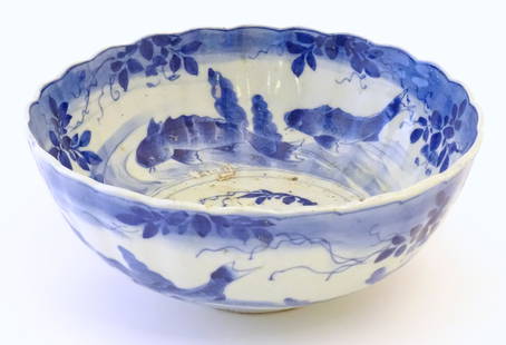 A large Chinese blue and white bowl with a scalloped edge, the body decorated with koi carp fish: A large Chinese blue and white bowl with a scalloped edge, the body decorated with koi carp fish amongst seaweed. Blue ring to outer rim of base. Approx. 5 1/4" high x 12 1/4" diameter