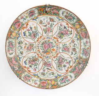 A Chinese / Cantonese famille rose charger decorated with flowers, foliage, birds, butterflies, etc.: A Chinese / Cantonese famille rose charger decorated with flowers, foliage, birds, butterflies, etc. Approx. 13 3/4" diameter