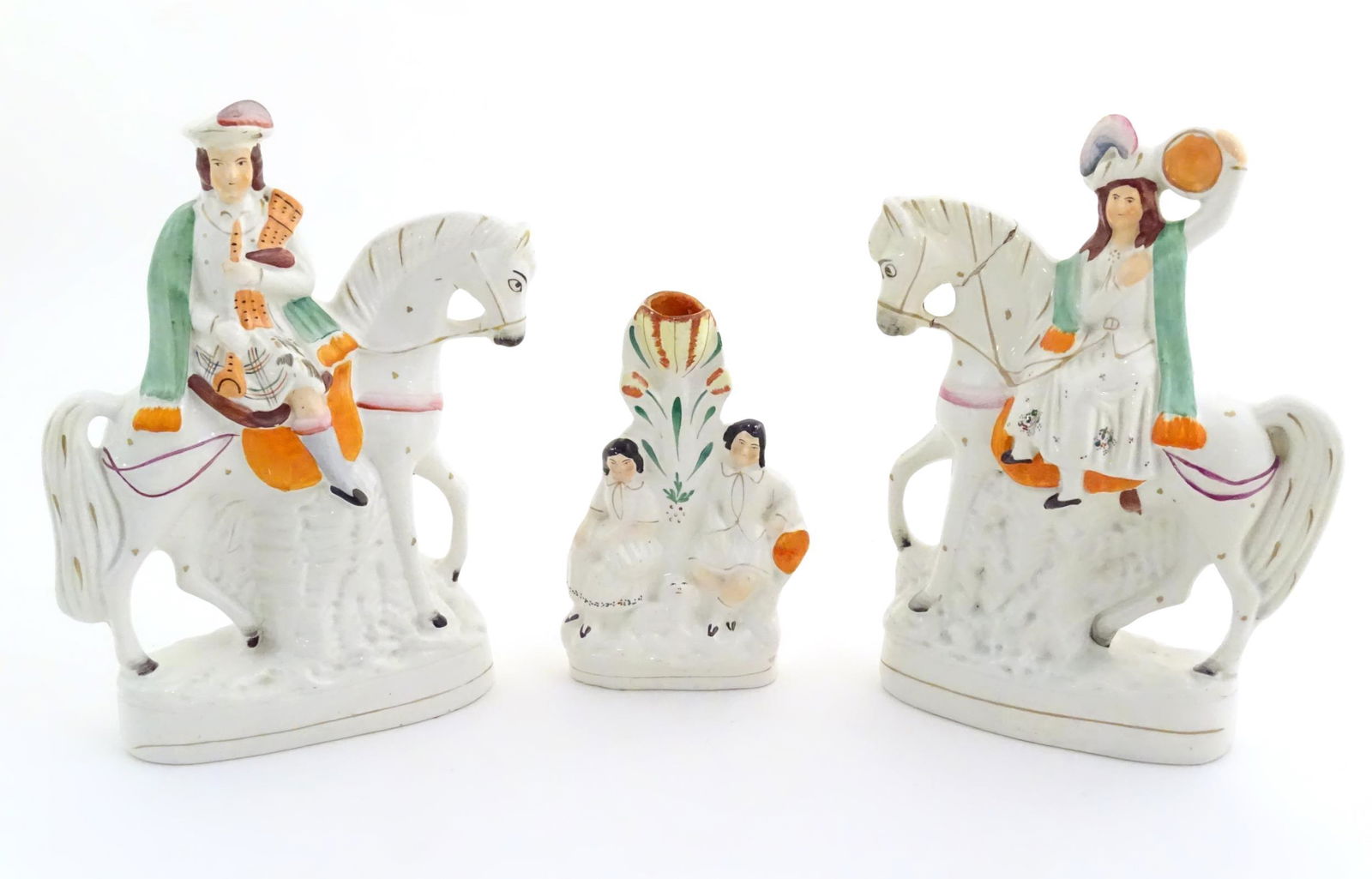 Three Victorian Staffordshire figures depicting male and female Scottish figures on horseback, and a (1 of 7)