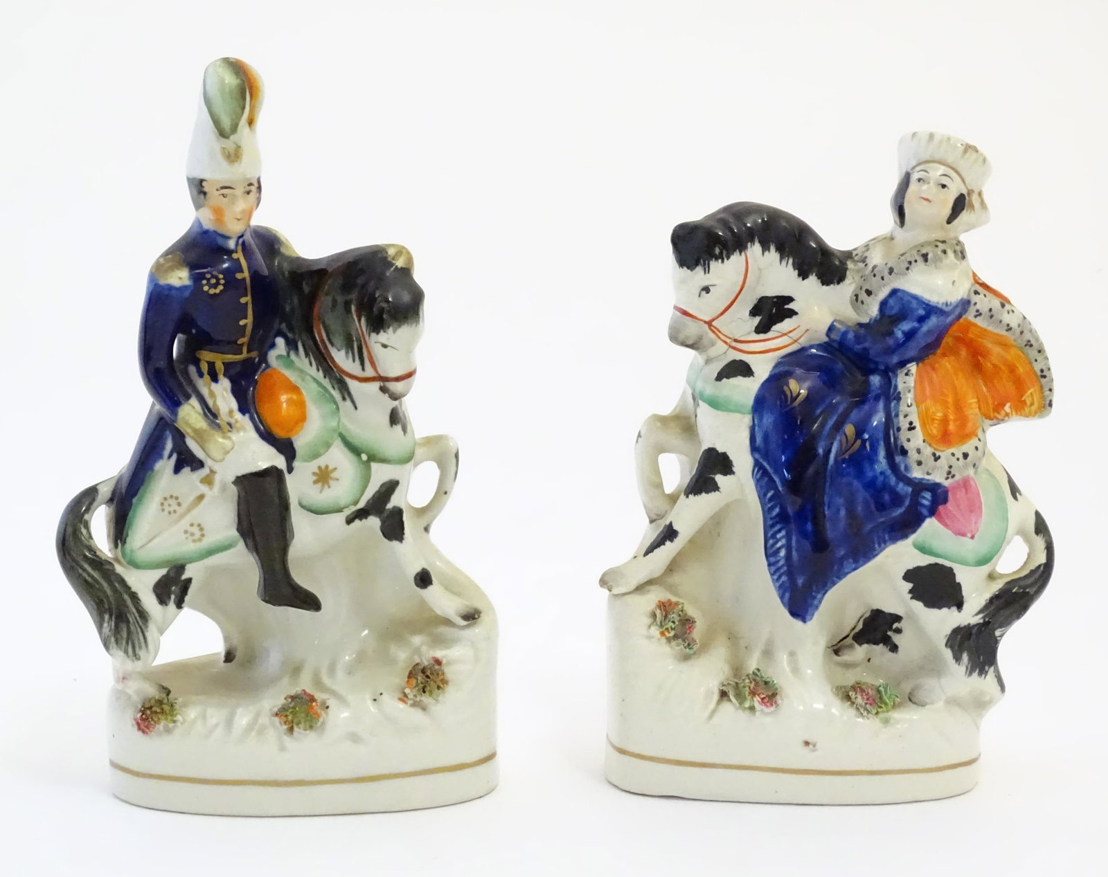 A pair of Victorian Staffordshire pottery figures depicting Albert and Victoria on horseback.: A pair of Victorian Staffordshire pottery figures depicting Albert and Victoria on horseback. Largest approx. 7 3/4" high (2)