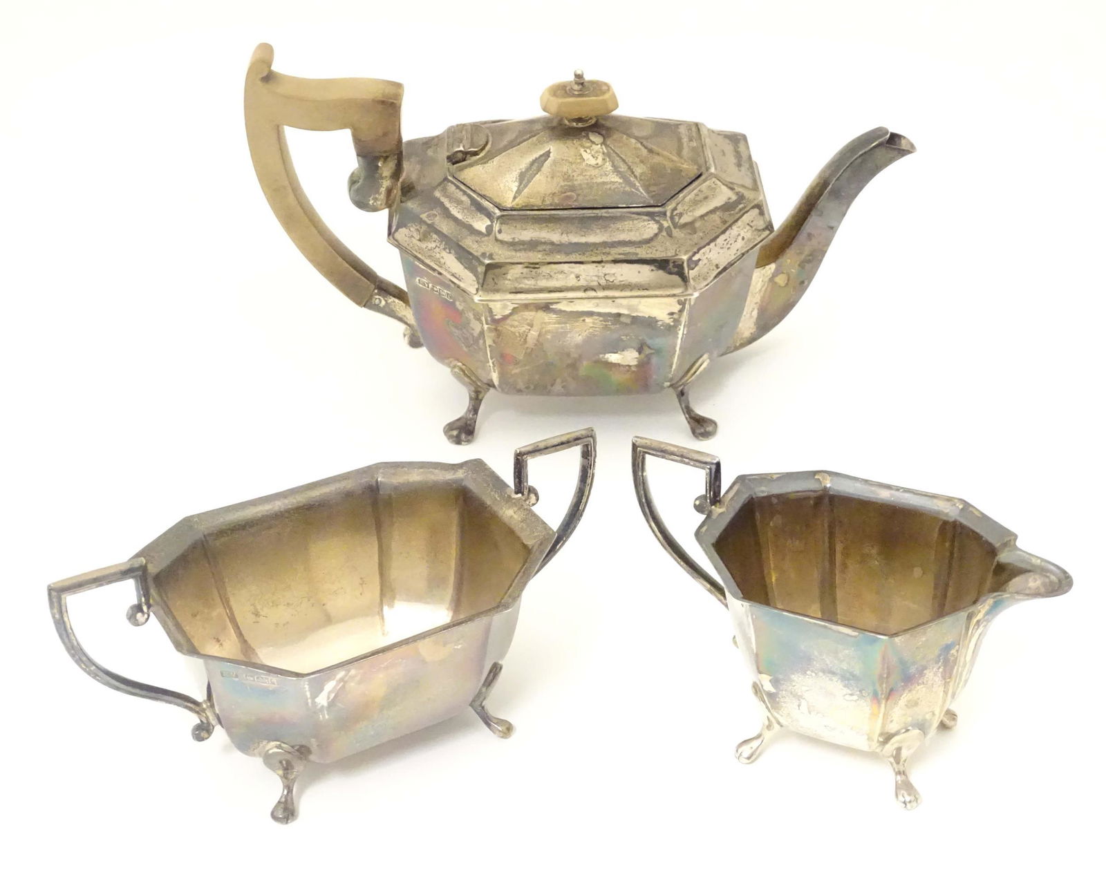 An Art Deco silver three piece tea set comprising tea pot, sugar and milk jug. Hallmarked 1933/34: An Art Deco silver three piece tea set comprising tea pot, sugar and milk jug. Hallmarked 1933/34 maker Viner's Ltd. The teapot Approx 10 1/4" long x 5 1/5" high (3)