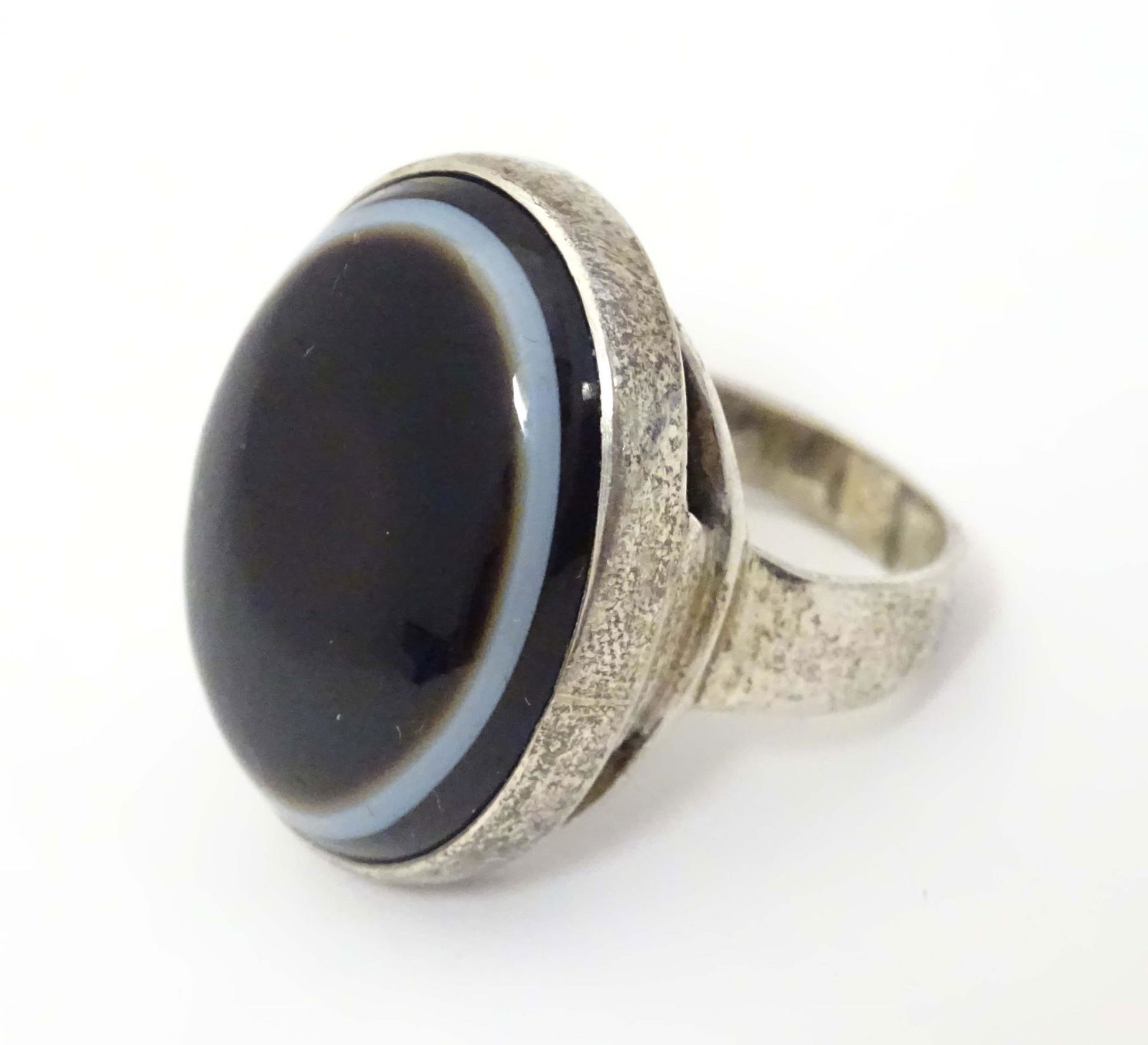 A silver ring set with banded agate cabochon to top, hallmarked London c. 1970. Ring size approx. N (1 of 6)
