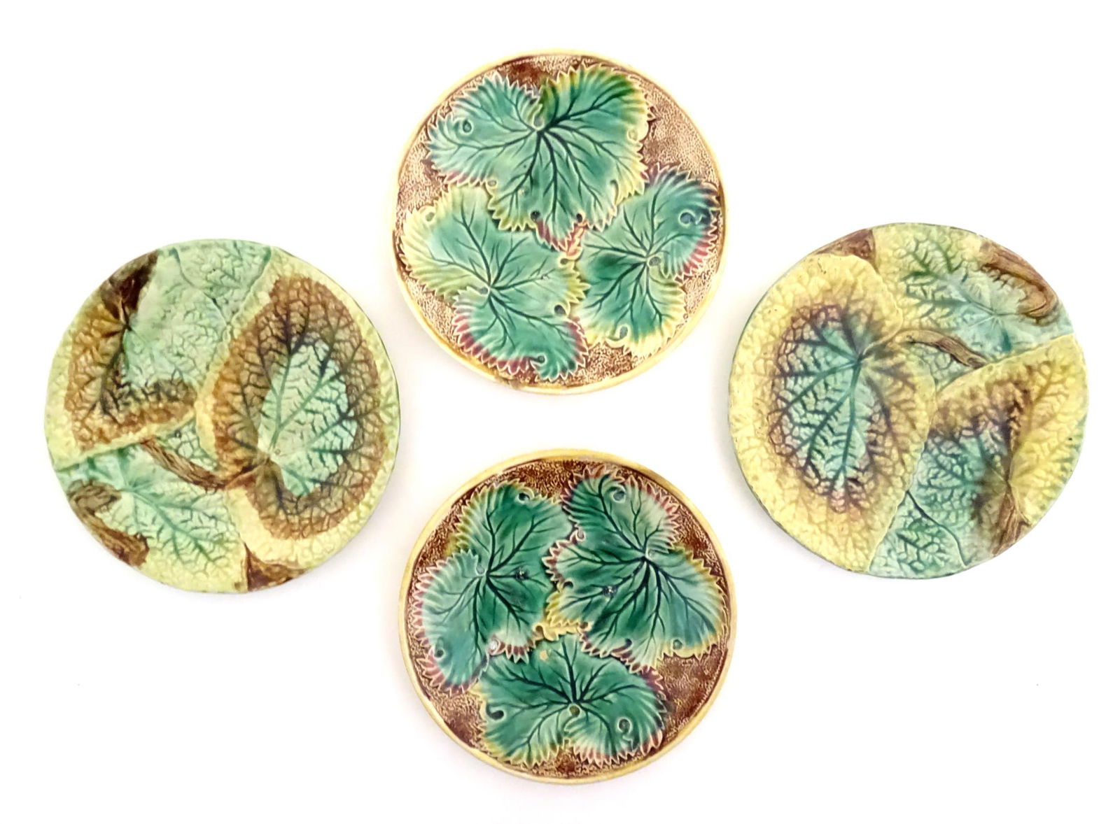 Four Victorian majolica leaf plates of circular form two with Begonia leaves, and two with (1 of 7)