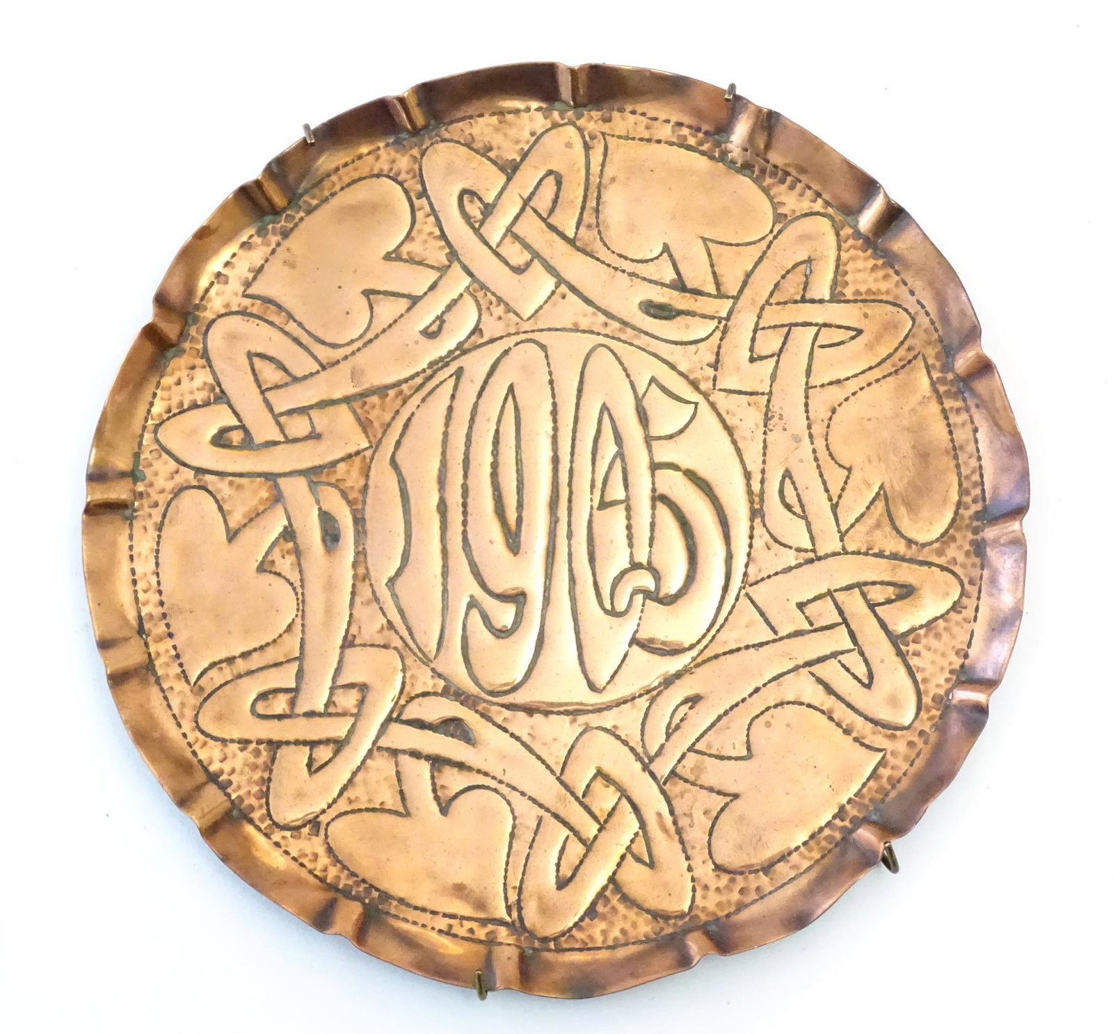 An Art Nouveau copper card tray with embossed decoration depicting stylised flowers and foliage, dat: An Art Nouveau copper card tray with embossed decoration depicting stylised flowers and foliage, dated 1905 to centre. In the manner of John Williams for Newton Class Cambridge. Approx. 8 1/2" diamete