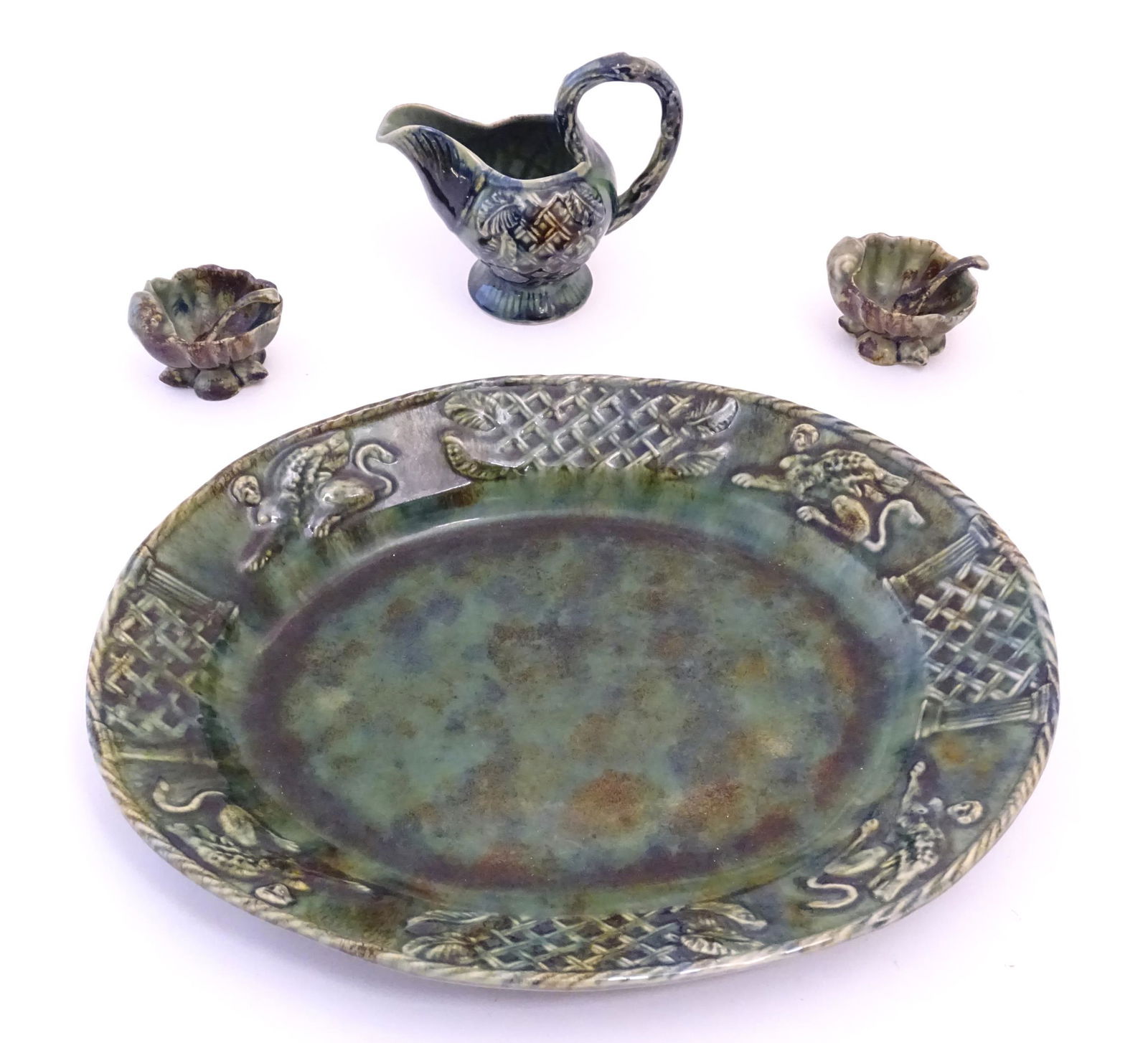 A quantity of Continental majolica wares with a mottled green glaze comprising a serving dish of (1 of 8)