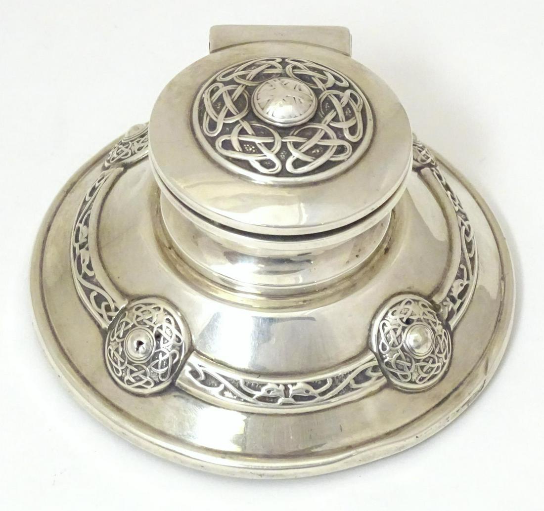 An Arts & Crafts silver inkwell of stylised capstan form with Celtic style decoration, hallmarked (1 of 6)