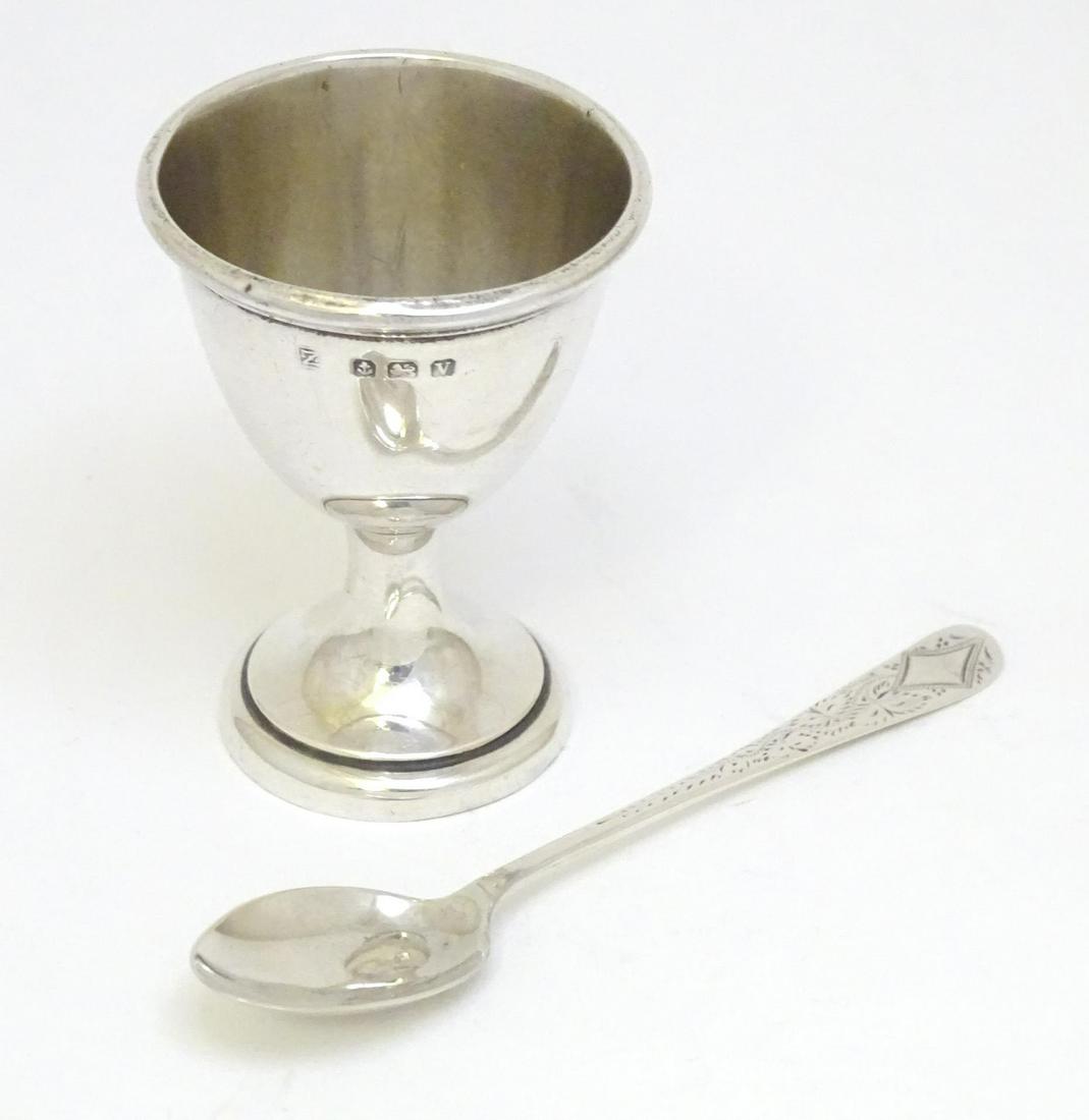 A silver egg cup hallmarked Birmingham 1945, maker A & J Zimmerman Ltd. Together with a silver (1 of 5)