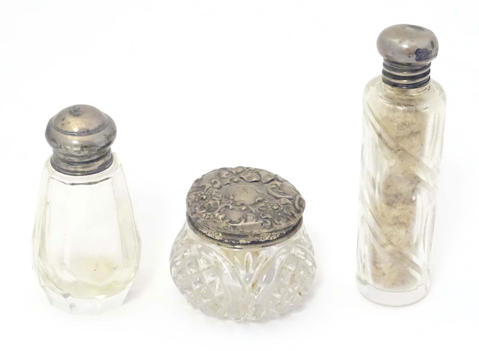 Two small silver lidded glass scent / perfume bottles hallmarked London 1904 makers Henry Perkins &: Two small silver lidded glass scent / perfume bottles hallmarked London 1904 makers Henry Perkins & Sons and John Thompson & Sons. Together with a small silver lidded glass dressing table pot hallmark