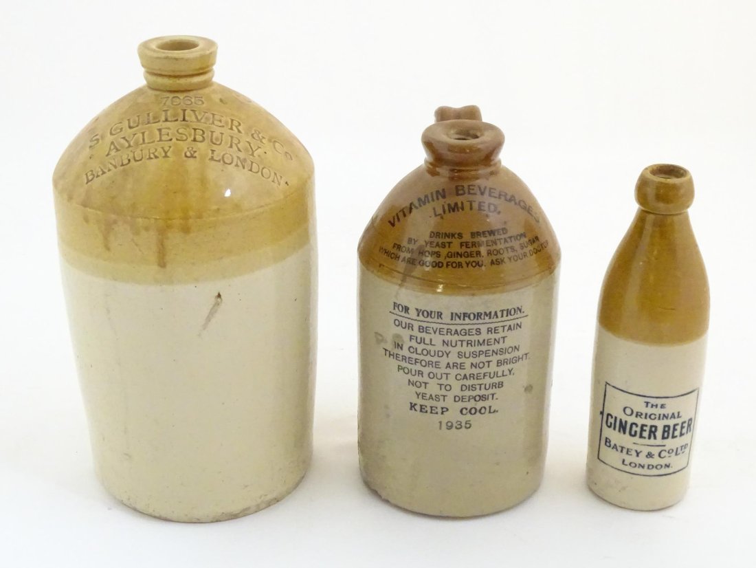 A trio of stoneware flagons, comprising an early 20thC beer/spirits carrier with impressed mark: (1 of 12)