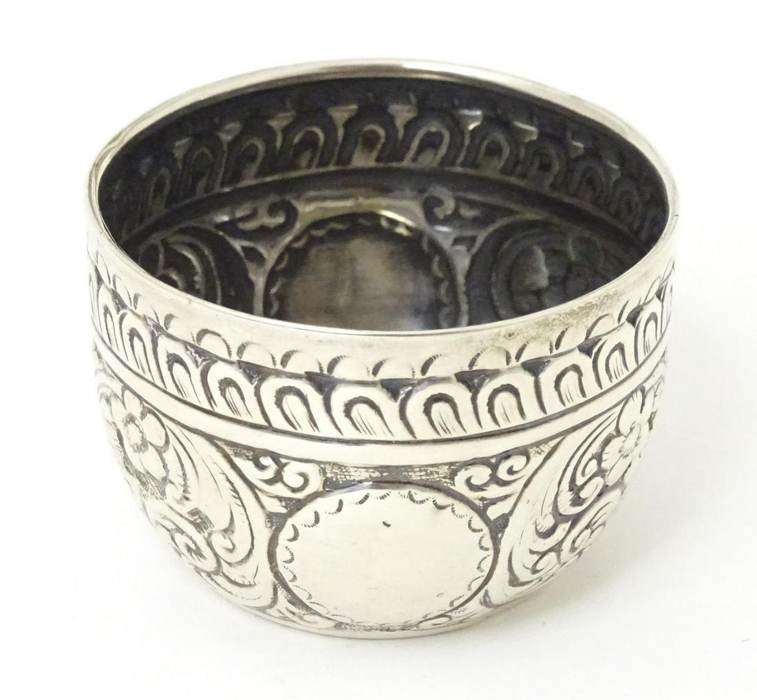 A small Victorian silver bowl with embossed decoration, hallmarked London 1882, maker Charles Stuart: A small Victorian silver bowl with embossed decoration, hallmarked London 1882, maker Charles Stuart Harris. Approx. 1 1/2" high x 2" diameter