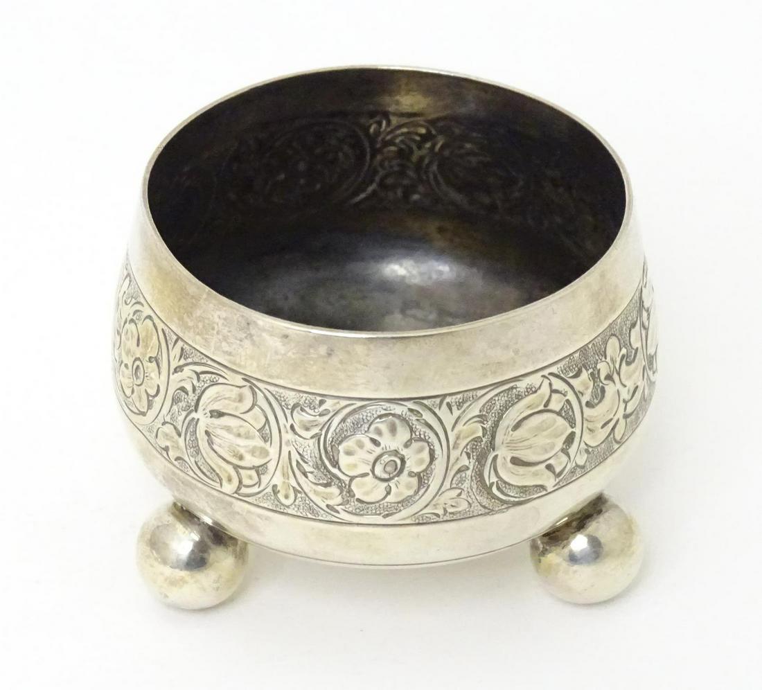 A Victorian silver salt with engraved decoration standing on three ball feet, hallmarked London: A Victorian silver salt with engraved decoration standing on three ball feet, hallmarked London 1875, maker Thomas Smily. Approx. 2" wide