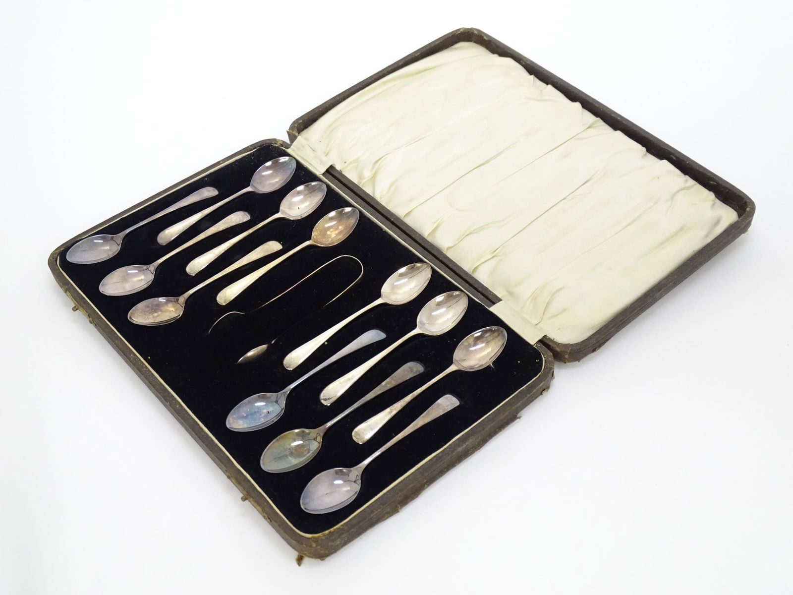 A set of twelve silver teaspoons with sugar tongs en suite, hallmarked Birmingham 1927-1929, maker (1 of 7)
