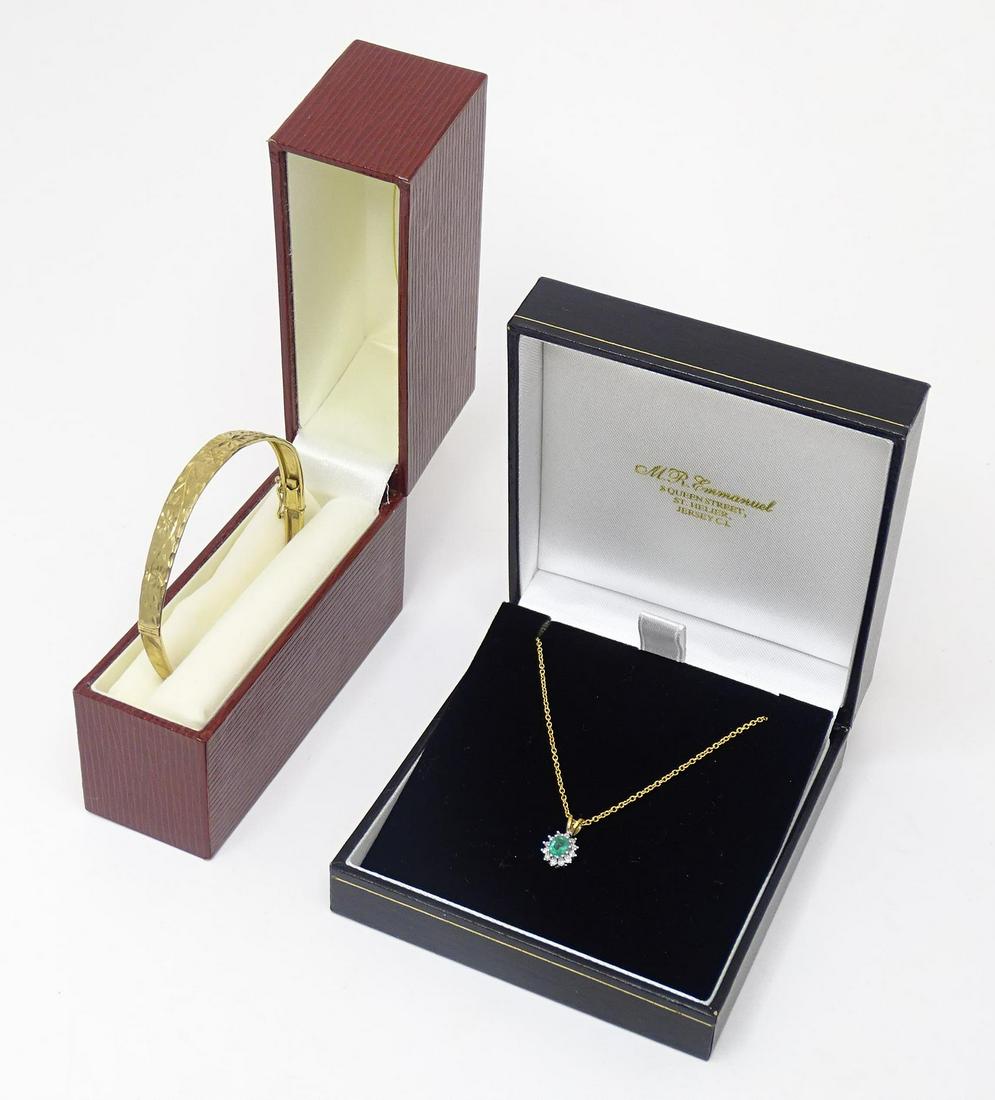 A 9ct gold bangle together with a 9ct gold pendant set with emerald and diamonds on a 9ct gold chain: A 9ct gold bangle together with a 9ct gold pendant set with emerald and diamonds on a 9ct gold chain approx. 18" long (2)