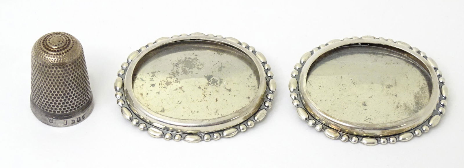 A pair of silver brooches with locket section to front hallmarked Birmingham 1982 maker Langstone: A pair of silver brooches with locket section to front hallmarked Birmingham 1982 maker Langstone Silver Works (Bernard Instone). Approx 1 3/4" wide. Together with a silver thimble hallmarked Birmingh