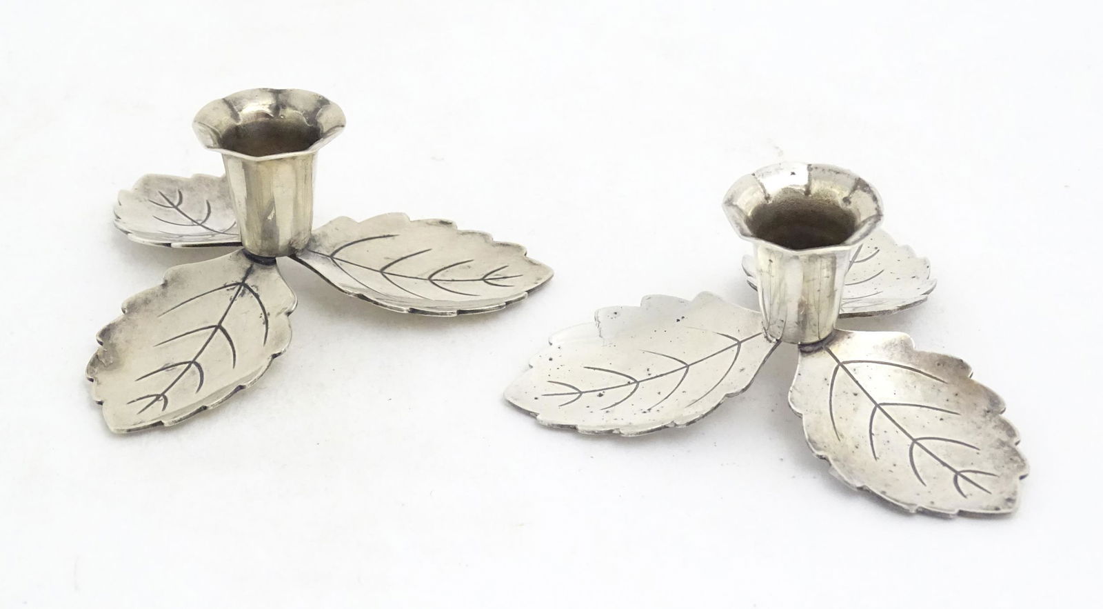 A pair of small Danish silver plate taper / candlestick holders with leaf detail. Maker Hans Jensen, (1 of 7)