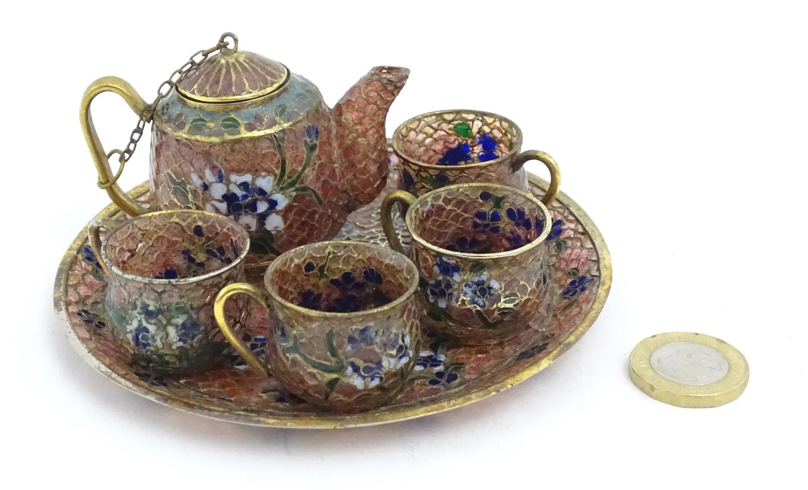 A plique a jour miniature tea set comprising teapot, four cups and a circular tray, each decorated (1 of 8)
