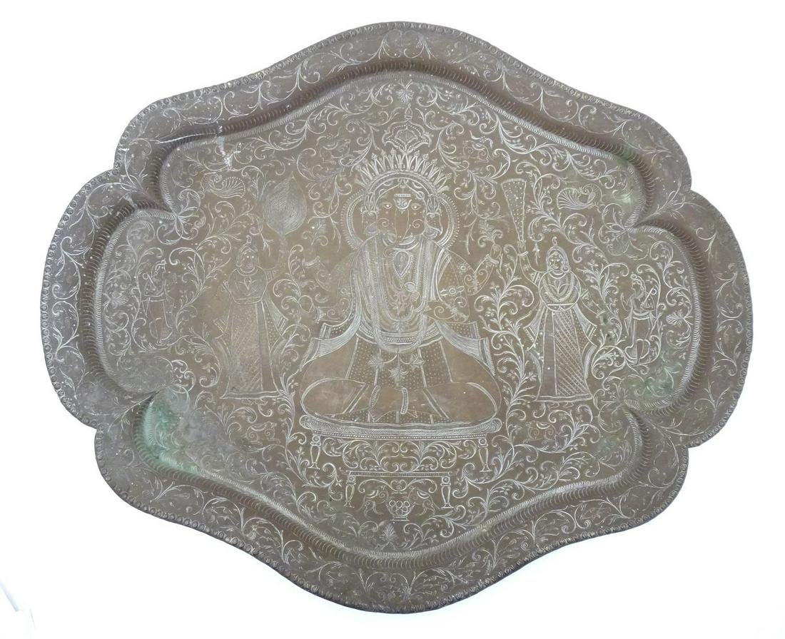 A 20thC Indian brass tray with lobed rim, engraved with deity Ganesha with attendants and scrolling (1 of 3)