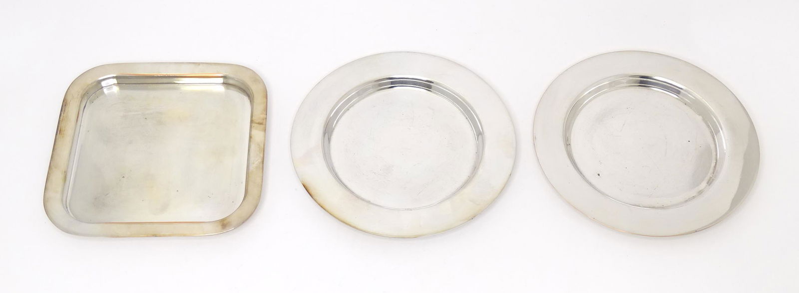 Three silver plate dishes marked with Chanel logo under. Largest 5 3/4 Three silver plate dishes marked with Chanel logo under. Largest 5 3/4