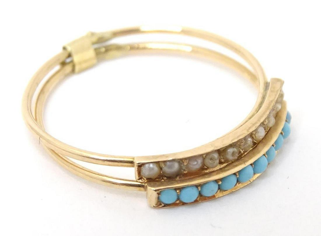 A gold twin band ring set with turquoise and seed pearls. Ring size approx M.  Please Note - we do (1 of 3)