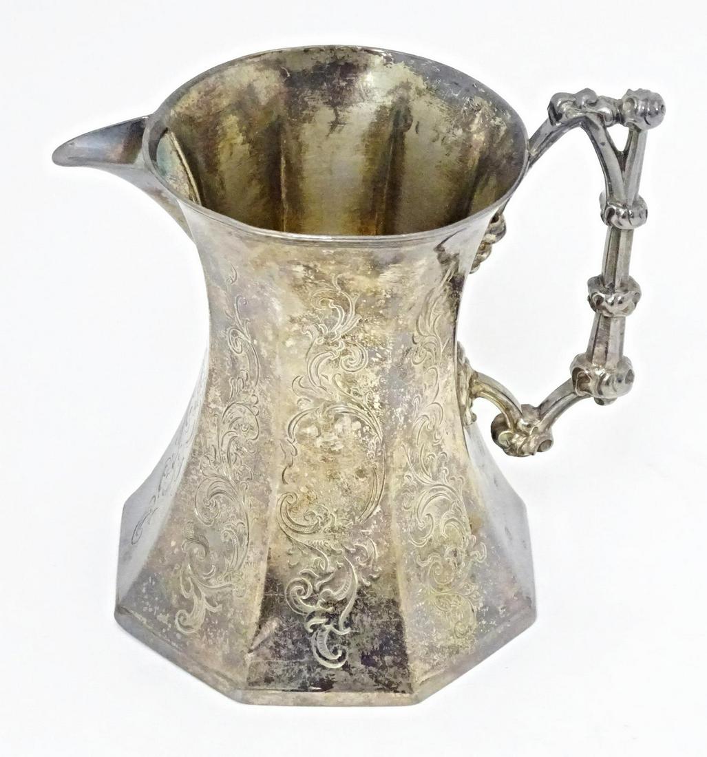 A Victorian silver jug of octagonal form with engraved decoration and Gothic Revival handle, (1 of 9)