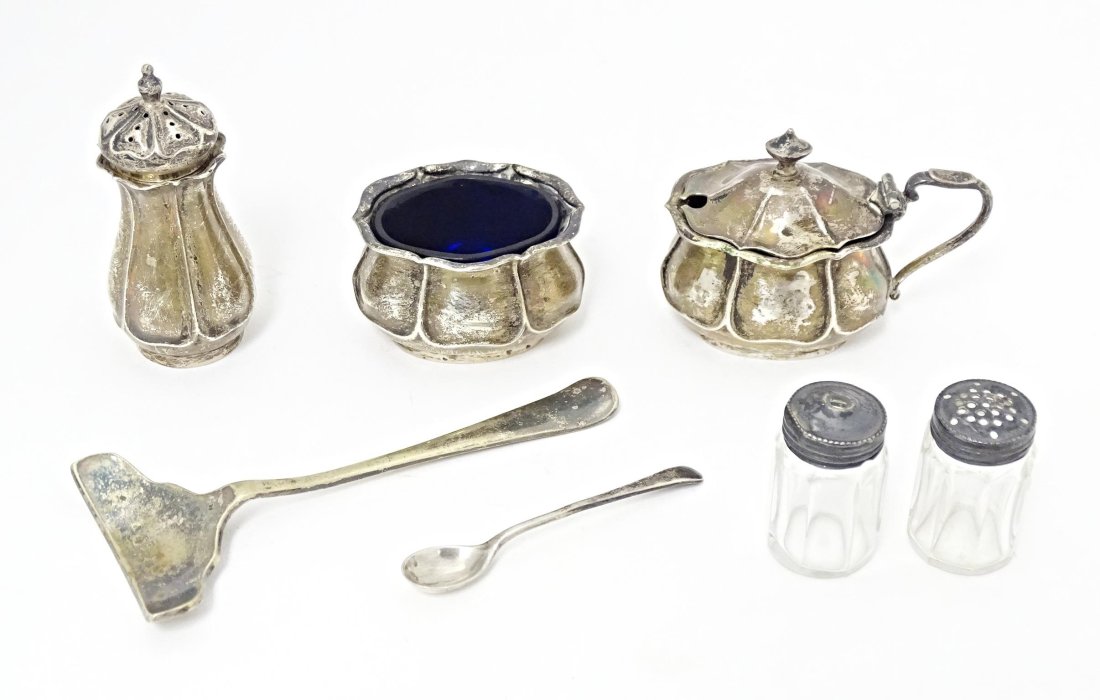 A quantity of assorted items to include a silver three piece cruet set comprising salt, mustard and (1 of 9)