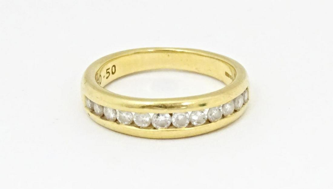 An 18ct gold half eternity ring with channel set diamonds. Ring size approx. L 1/2Please Note - we (1 of 6)