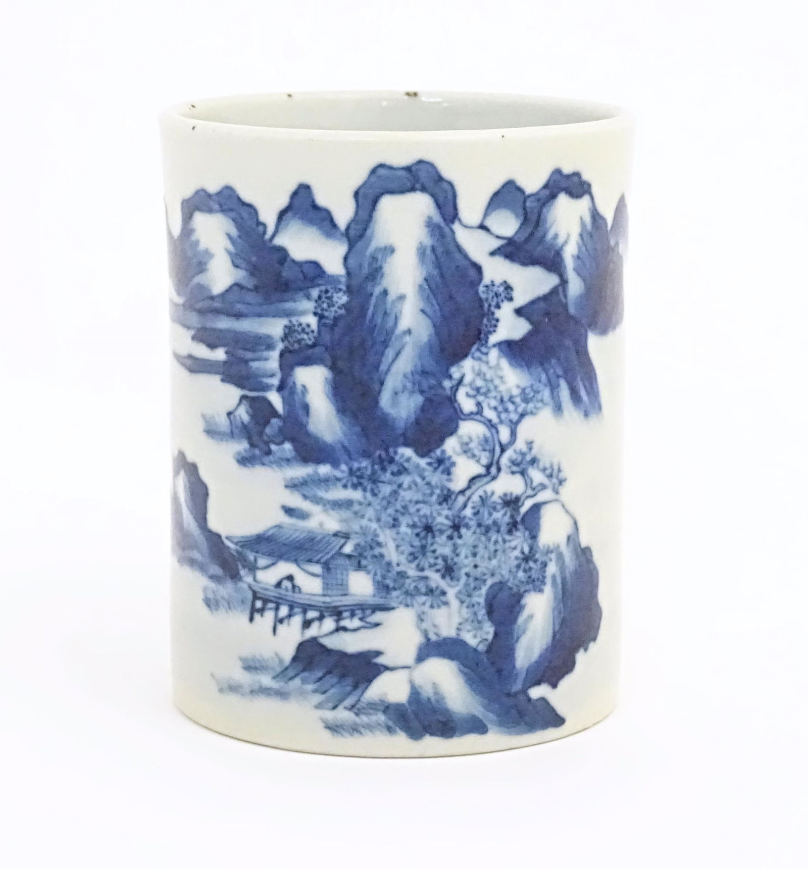 A Chinese blue and white brush pot of cylindrical form decorated with a mountain landscape. Approx. (1 of 6)