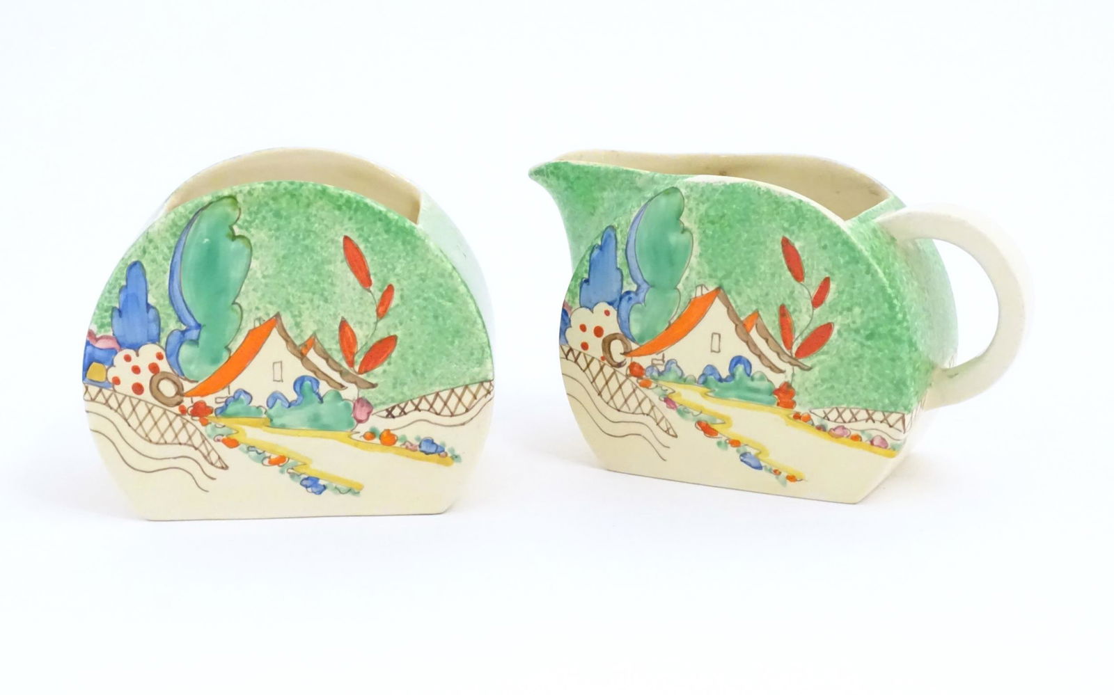 A Clarice Cliff milk jug and sugar bowl decorated in the Chalet pattern. Marked under. Sugar bowl (1 of 8)