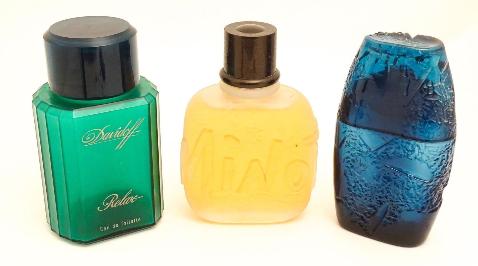 Three large / oversized shop display advertising perfume bottles comprising Minotaur by Paloma &: Three large / oversized shop display advertising perfume bottles comprising Minotaur by Paloma & Picasso, Horizon by Guy Laroche, and Relax by Davidoff. Largest approx. 12" high (3)