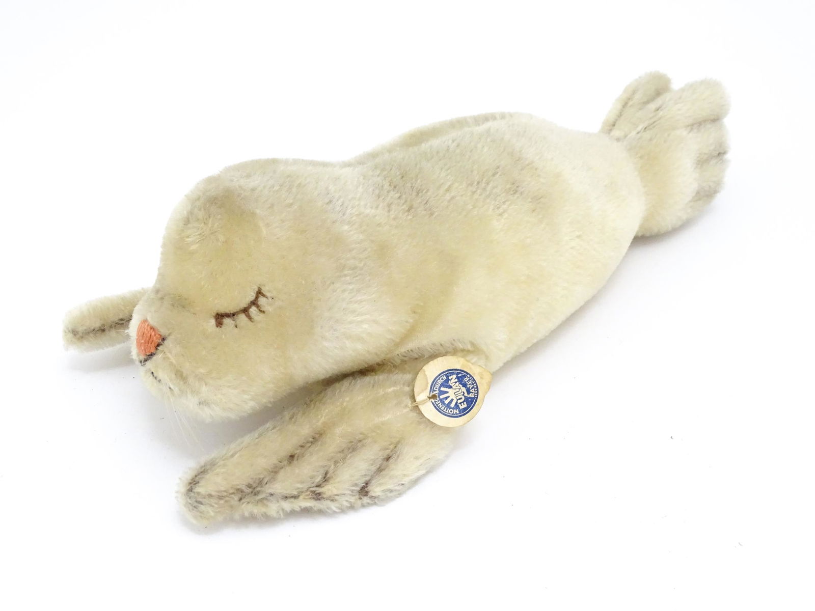 Toy: A 20thC Steiff mohair soft toy modelled as a sleeping seal - Floppy Robby, with stitched nose, (1 of 10)