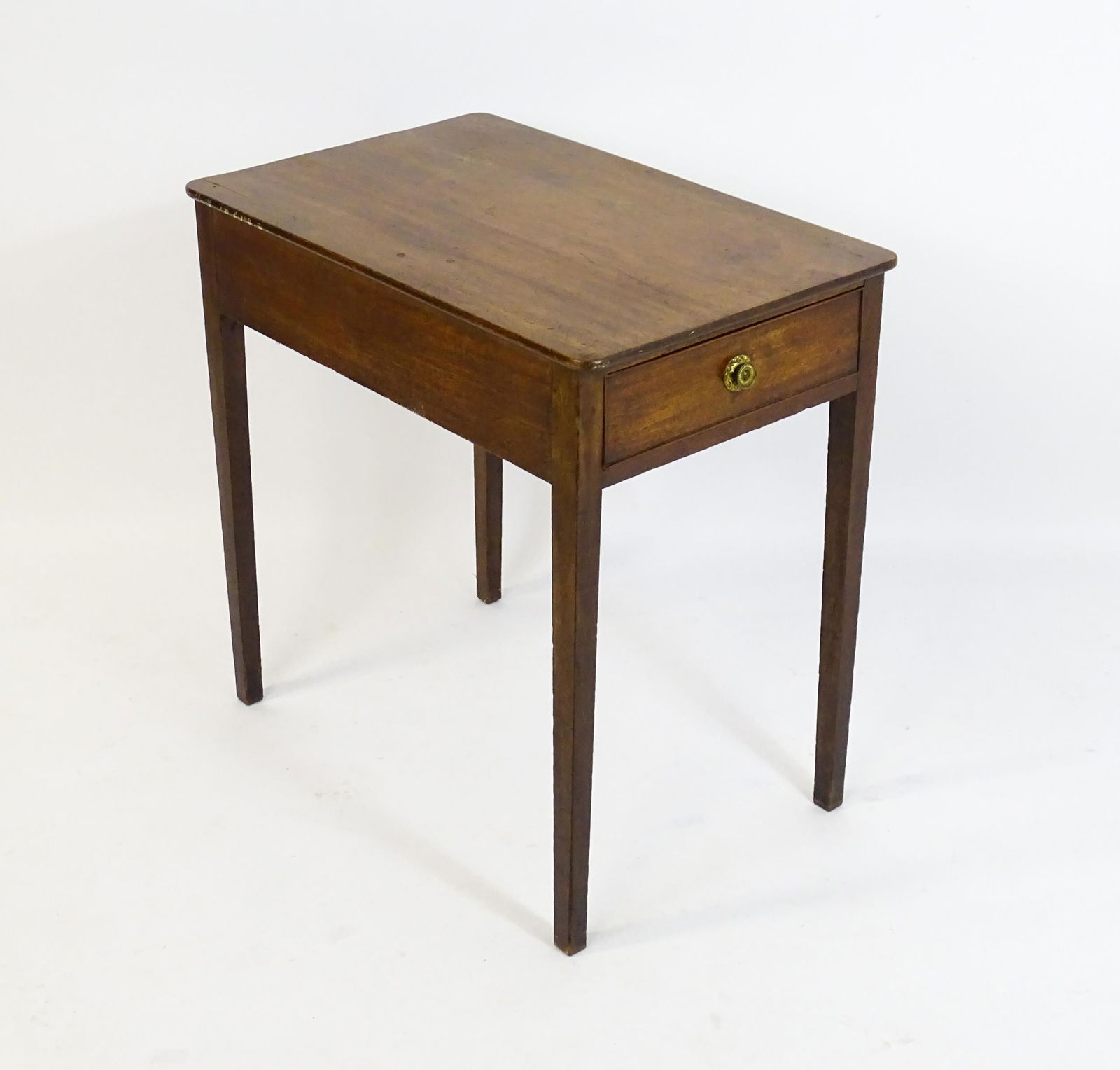 An early 19thC mahogany side table with a single short drawer to one end and raised on four tapering: An early 19thC mahogany side table with a single short drawer to one end and raised on four tapering legs. 30" wide x 19" deep x 29" high.