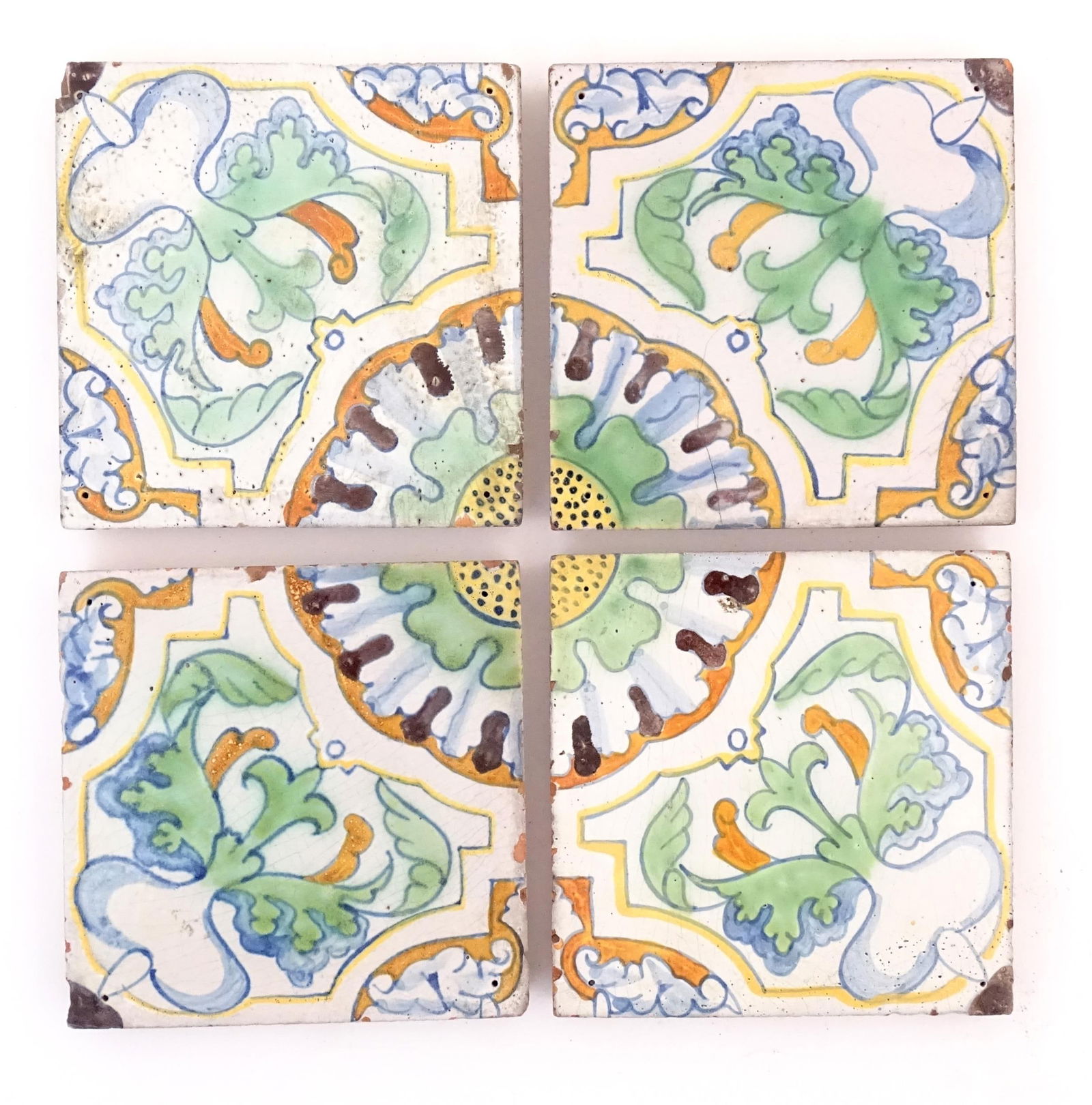 Four terracotta tiles with floral and foliate motifs, by Frederick Garrard at the Millwall Pottery, (1 of 6)