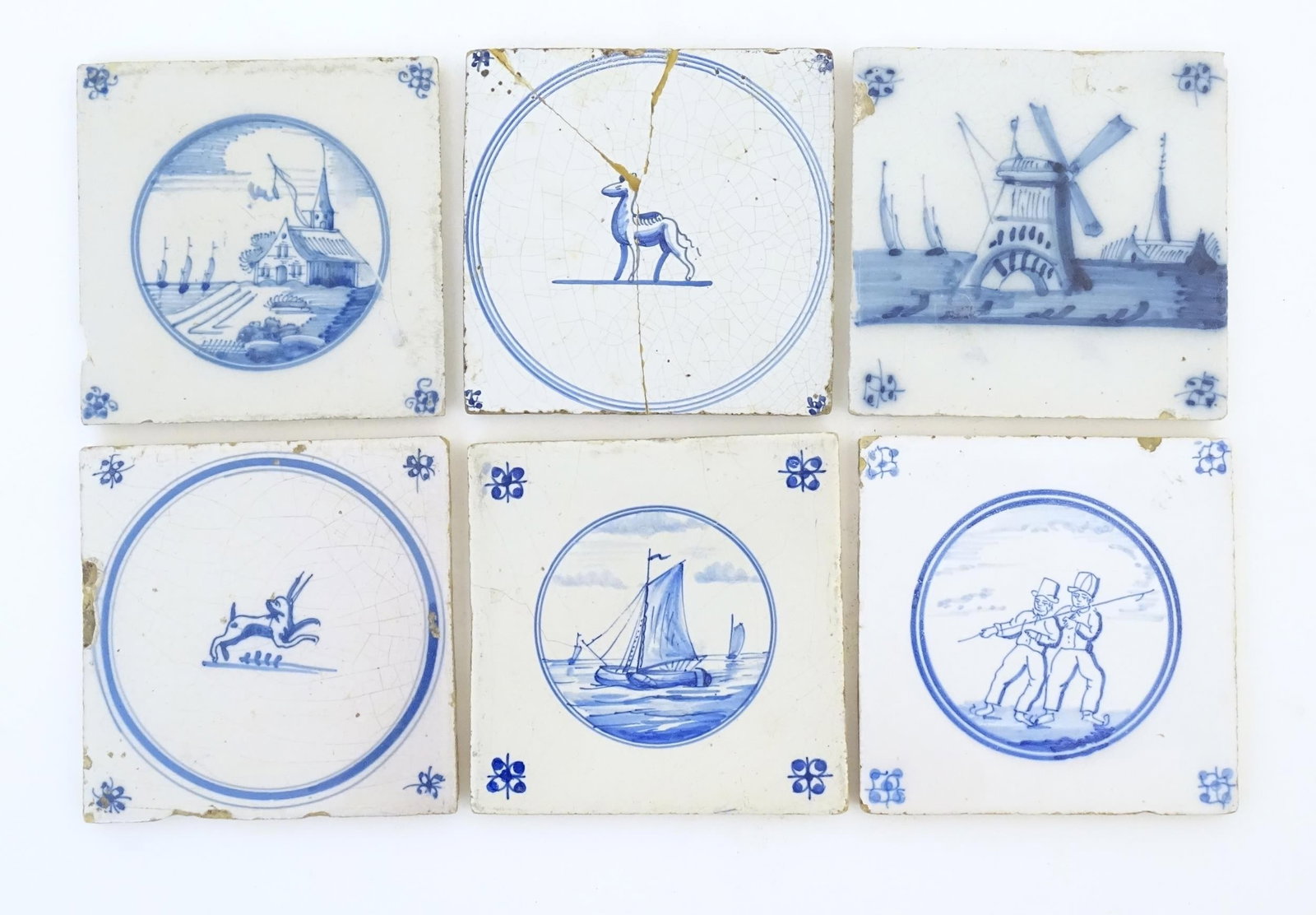 Six blue and white Delft tiles, decoration to include a seascape with boats, windmill with boats: Six blue and white Delft tiles, decoration to include a seascape with boats, windmill with boats beyond, Church landscape, figures and animals. Approx. 5" x 5" (6)Please Note - we do not make referenc