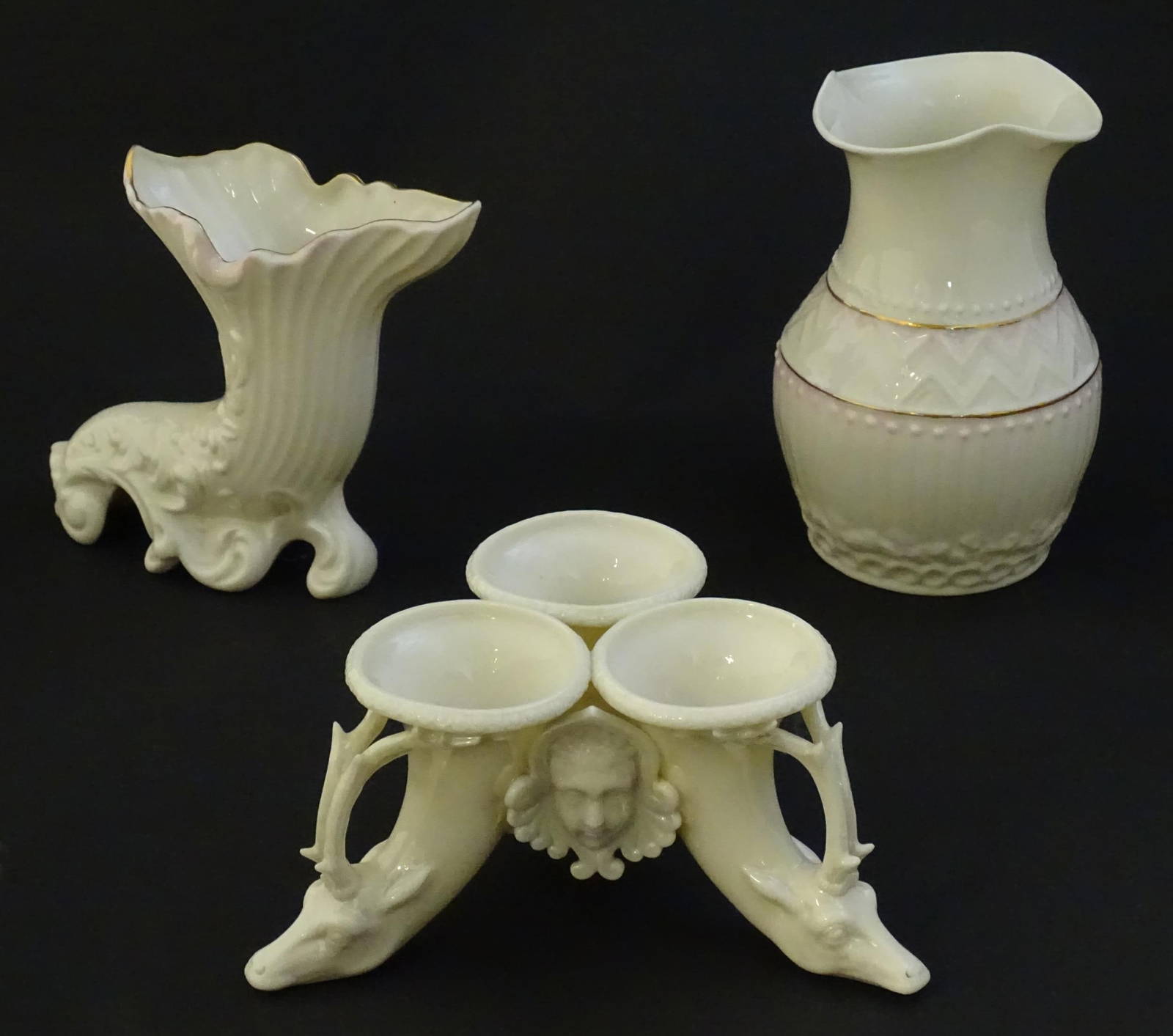 Two Items Of Belleek Comprising A Cornucopia Spill Vase And Blush Pink Vase With Shaped Rim