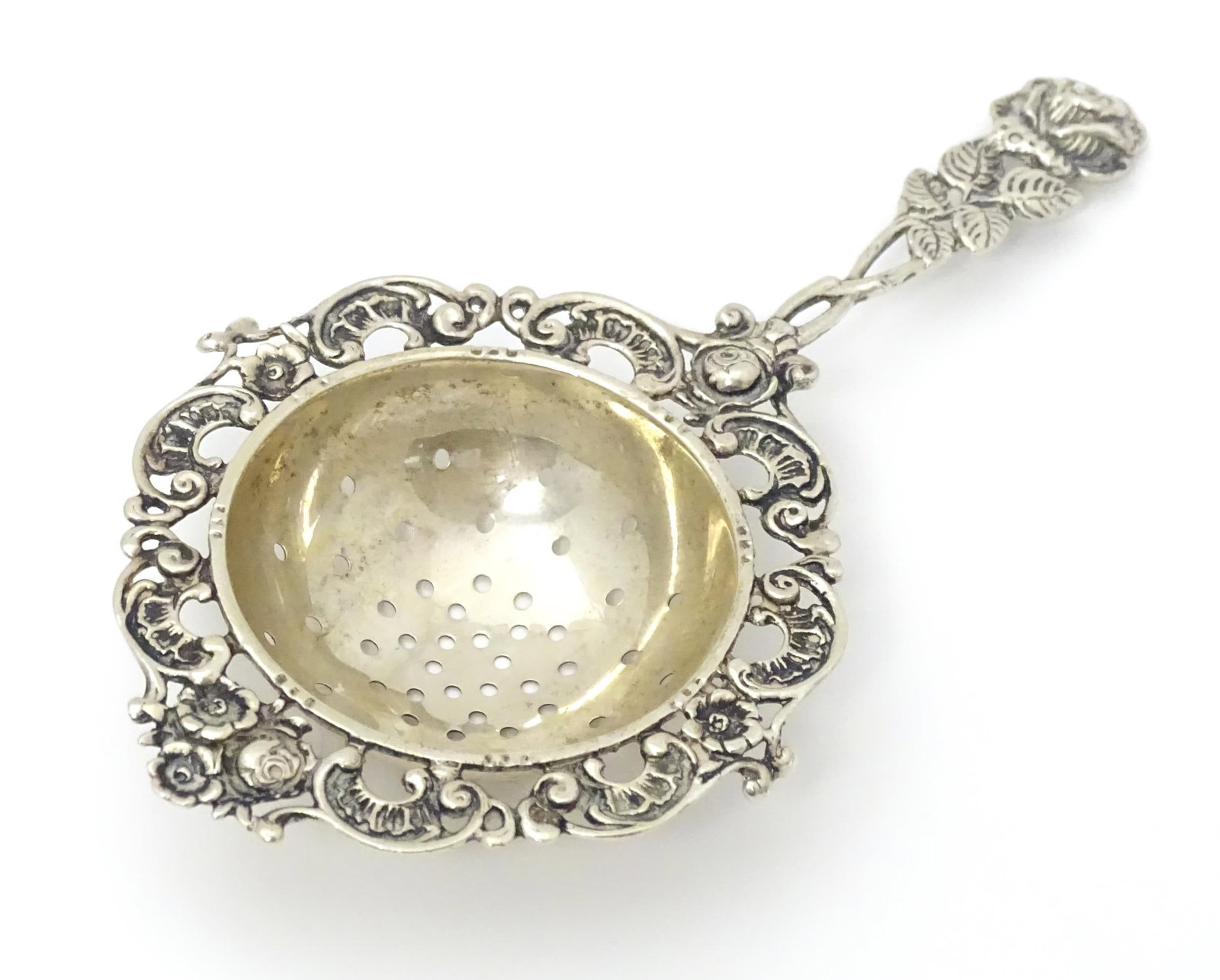 A Continental .835 silver tea / lemon strainer with floral detail to handle. Approx. 5 1/2" long (1 of 7)