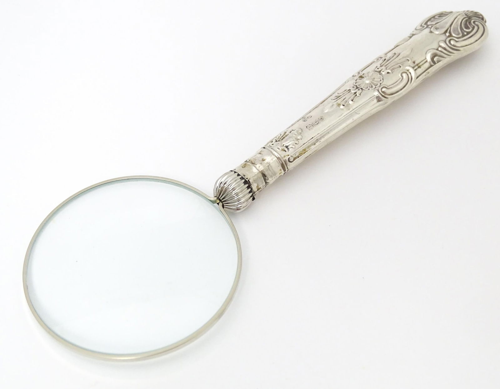 A silver handled magnifying glass.  Approx. 6 1/4" long Please Note - we do not make reference to (1 of 6)