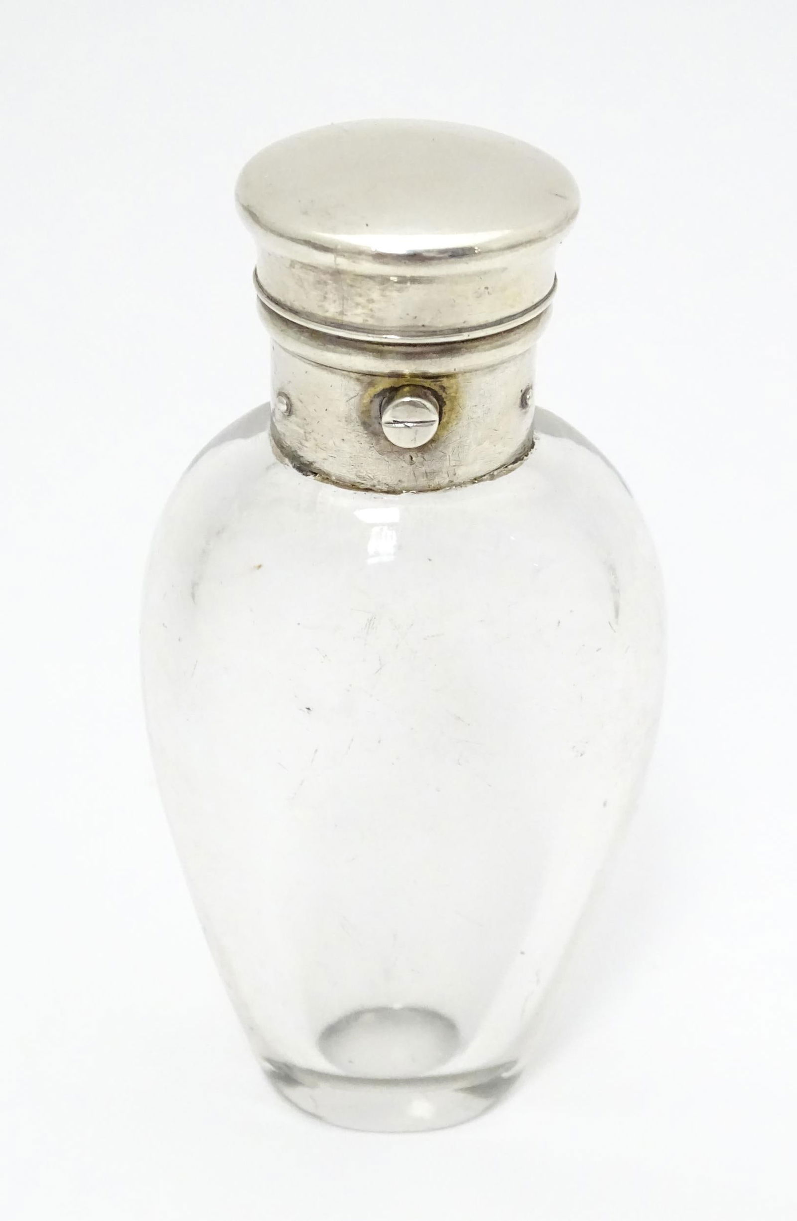 A glass scent / perfume bottle with white metal lid opening to revival Crown mark titled WES. (1 of 8)