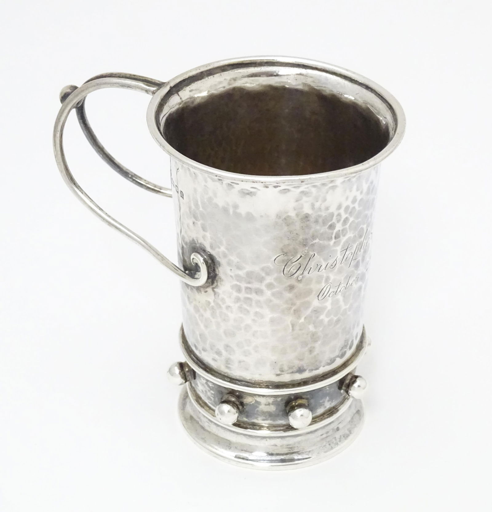 An Arts & Crafts silver christening mug with hammered decoration, banded spherical ball detail and (1 of 14)