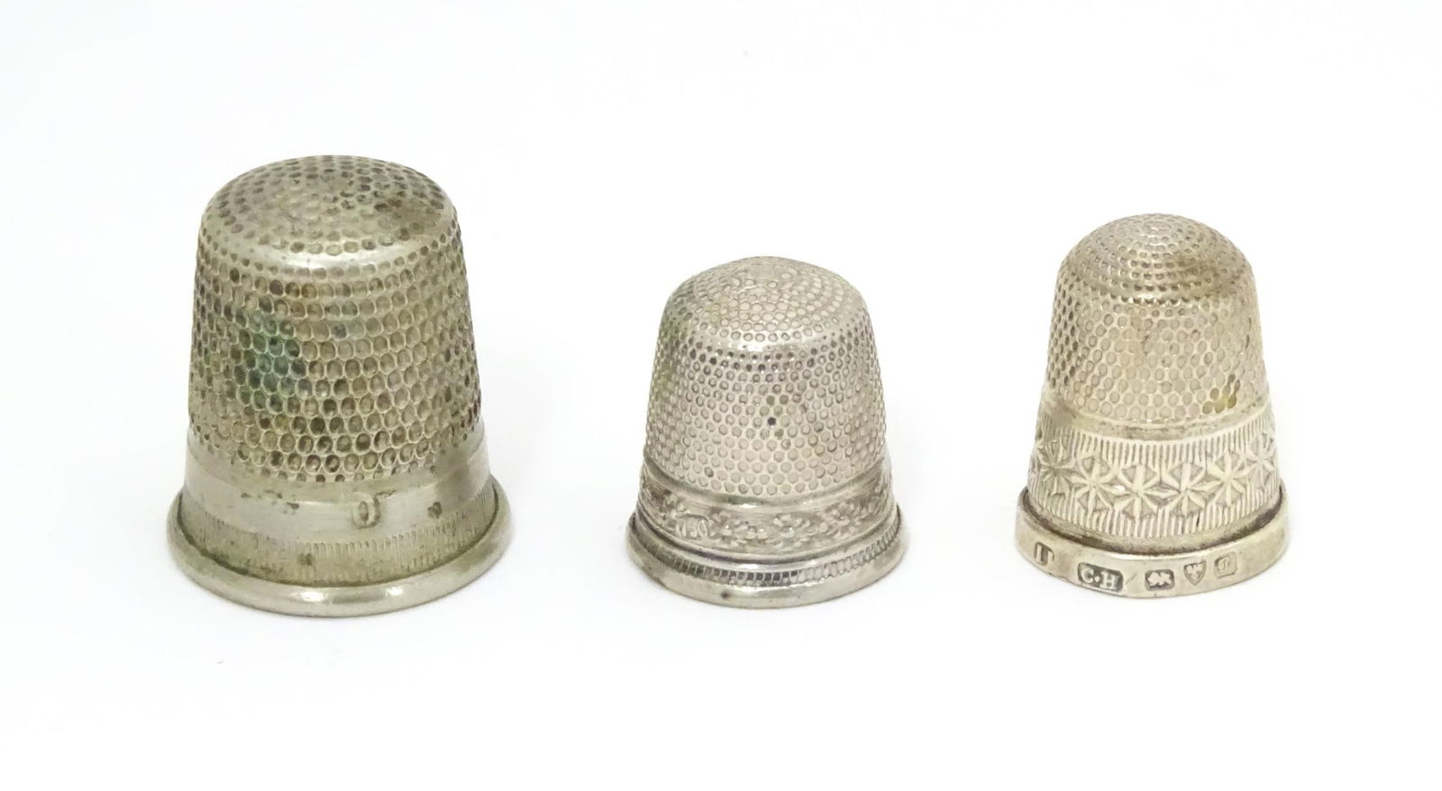 Three thimbles comprising a silver thimble hallmarked Chester 1903, maker Charles Horner, and two (1 of 6)