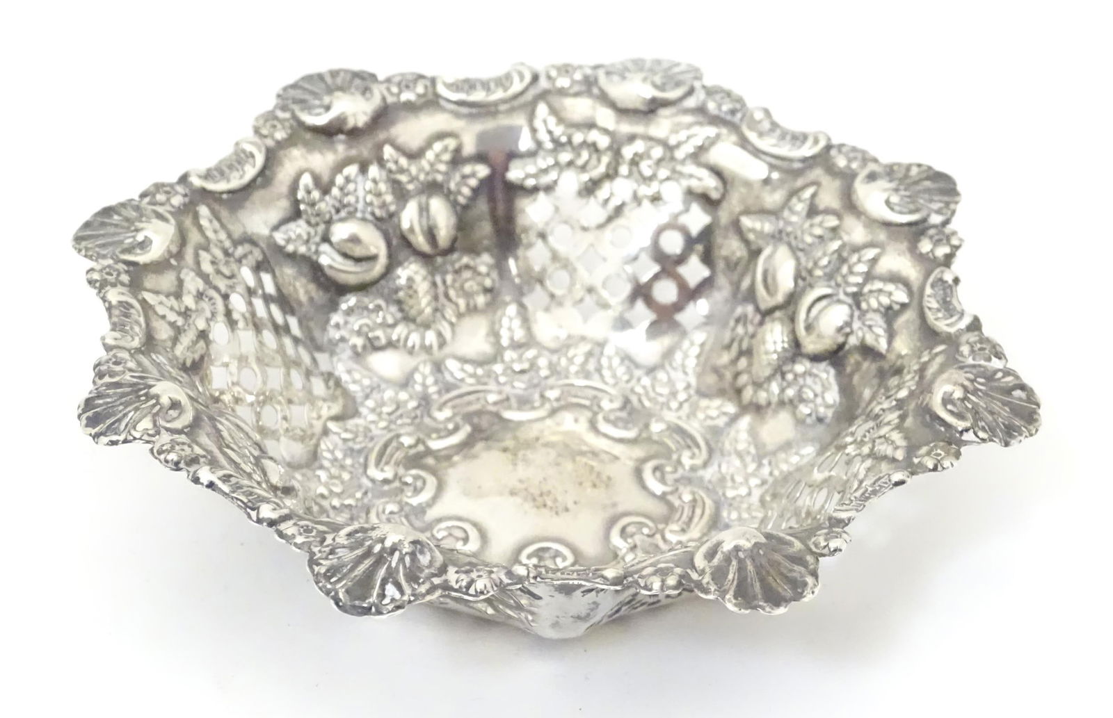 A silver pin dish with pierced and embossed decoration. Hallmarked Birmingham 1900 maker Miller (1 of 8)