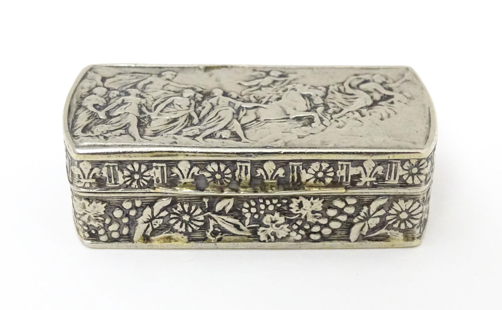 An Italian white metal pill box of rectangular form with embossed decoration. Marked Italy under. (1 of 7)