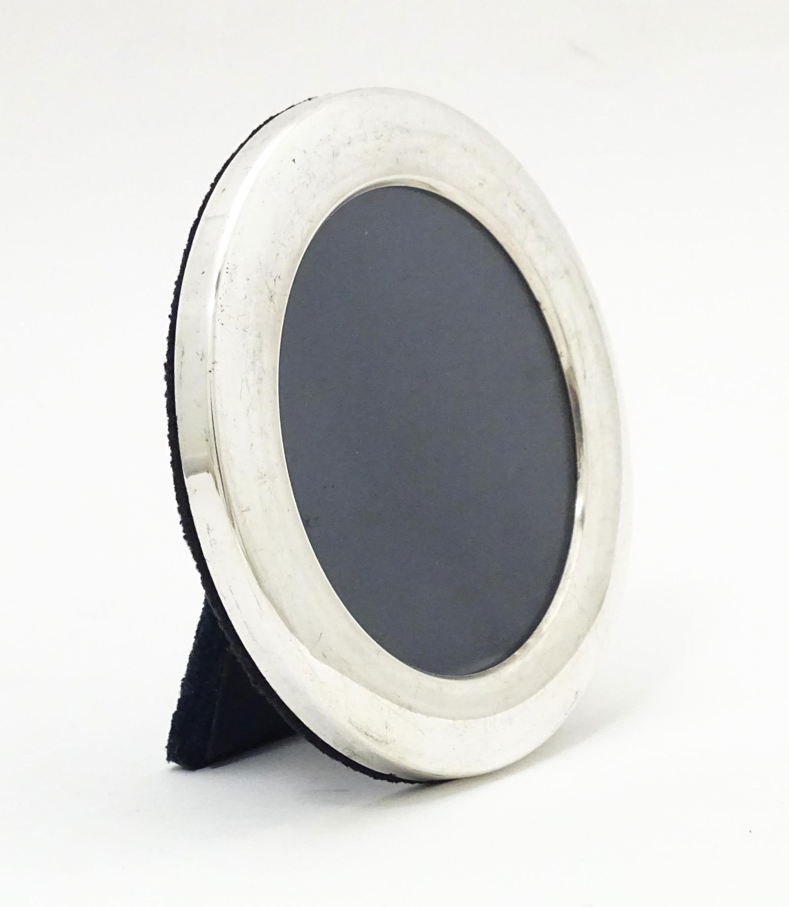 An easel back photograph frame of circular form with silver surround hallmarked Sheffield 2002 maker (1 of 5)