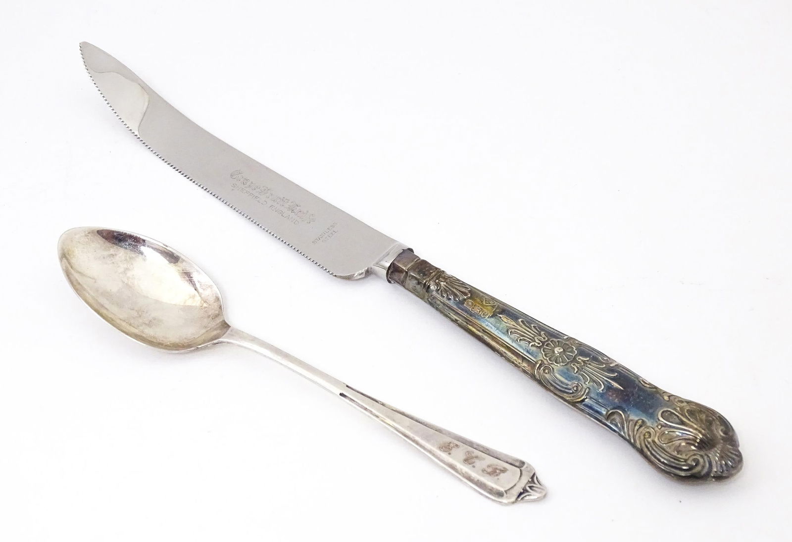 A silver handled Grapefruit knife hallmarked Sheffield 1977 maker Harrison Brothers together with a (1 of 6)