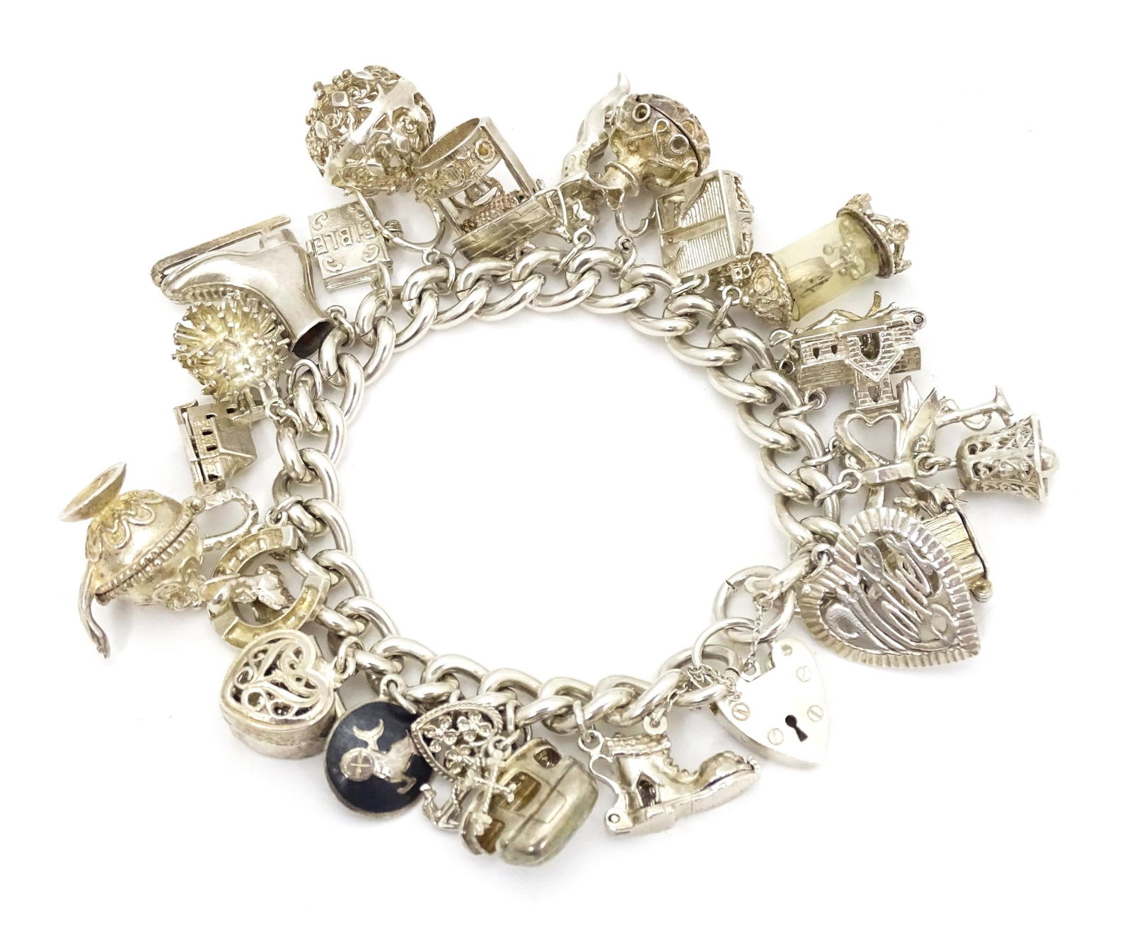 A silver charm bracelet set with a large quantity of assorted silver, white metal and silver plate (1 of 8)