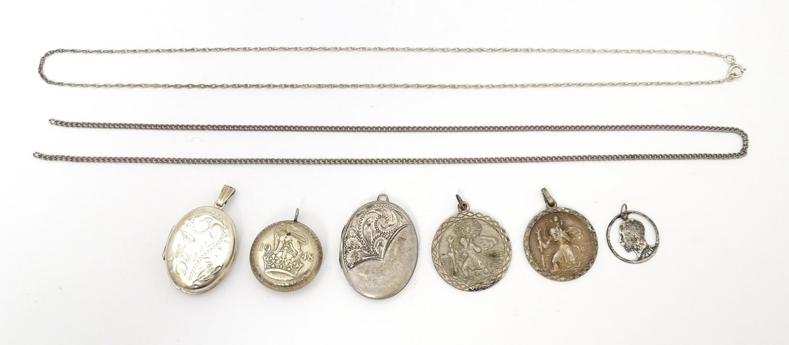 A quantity of assorted silver and white metal pendants and chains to include lockets, St (1 of 7)