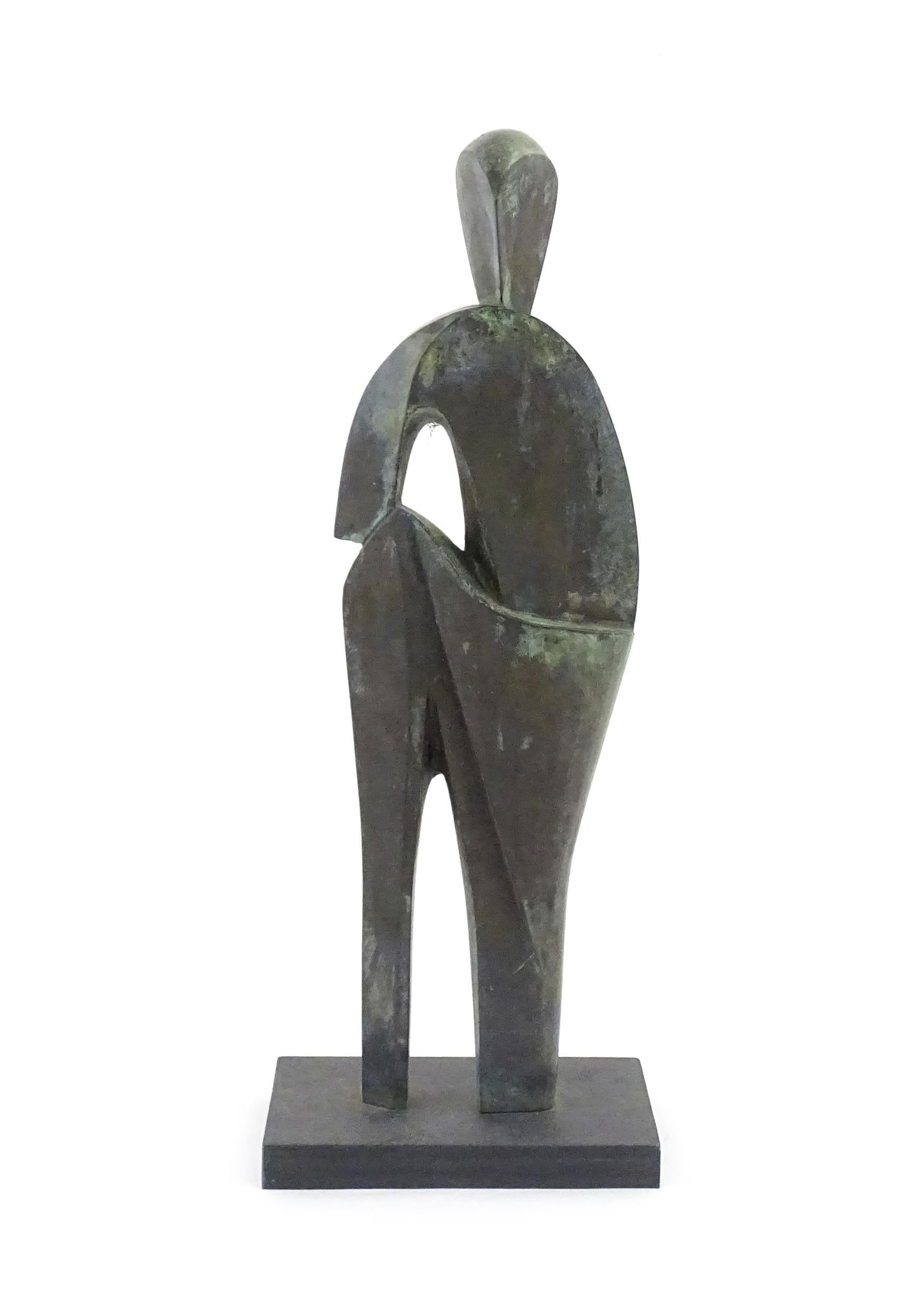 A 20thC cast bronze sculpture depicting a stylised standing figure. In the manner of JD Hansen.: A 20thC cast bronze sculpture depicting a stylised standing figure. In the manner of JD Hansen. Approx. 18 1/4" high overallPlease Note - we do not make reference to the condition of lots within descr