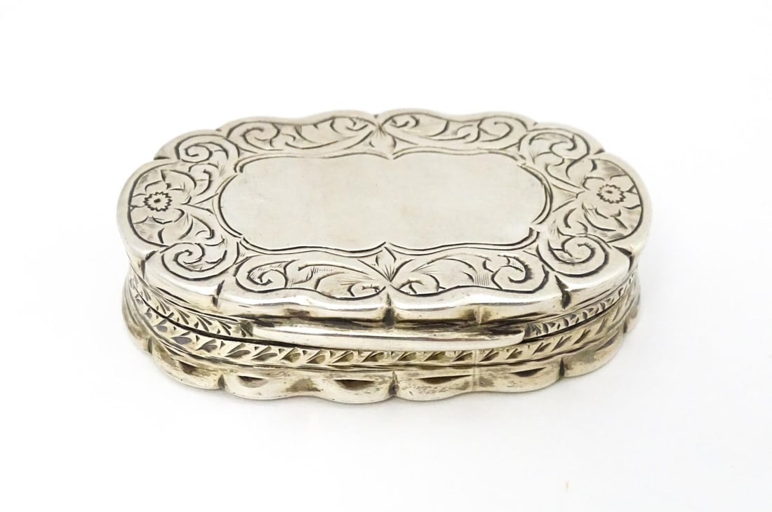 A silver pill box with engraved decoration hallmarked Birmingham 1920, maker George Randle. Approx.: A silver pill box with engraved decoration hallmarked Birmingham 1920, maker George Randle. Approx. 1 3/4" widePlease Note - we do not make reference to the condition of lots within descriptions. We a