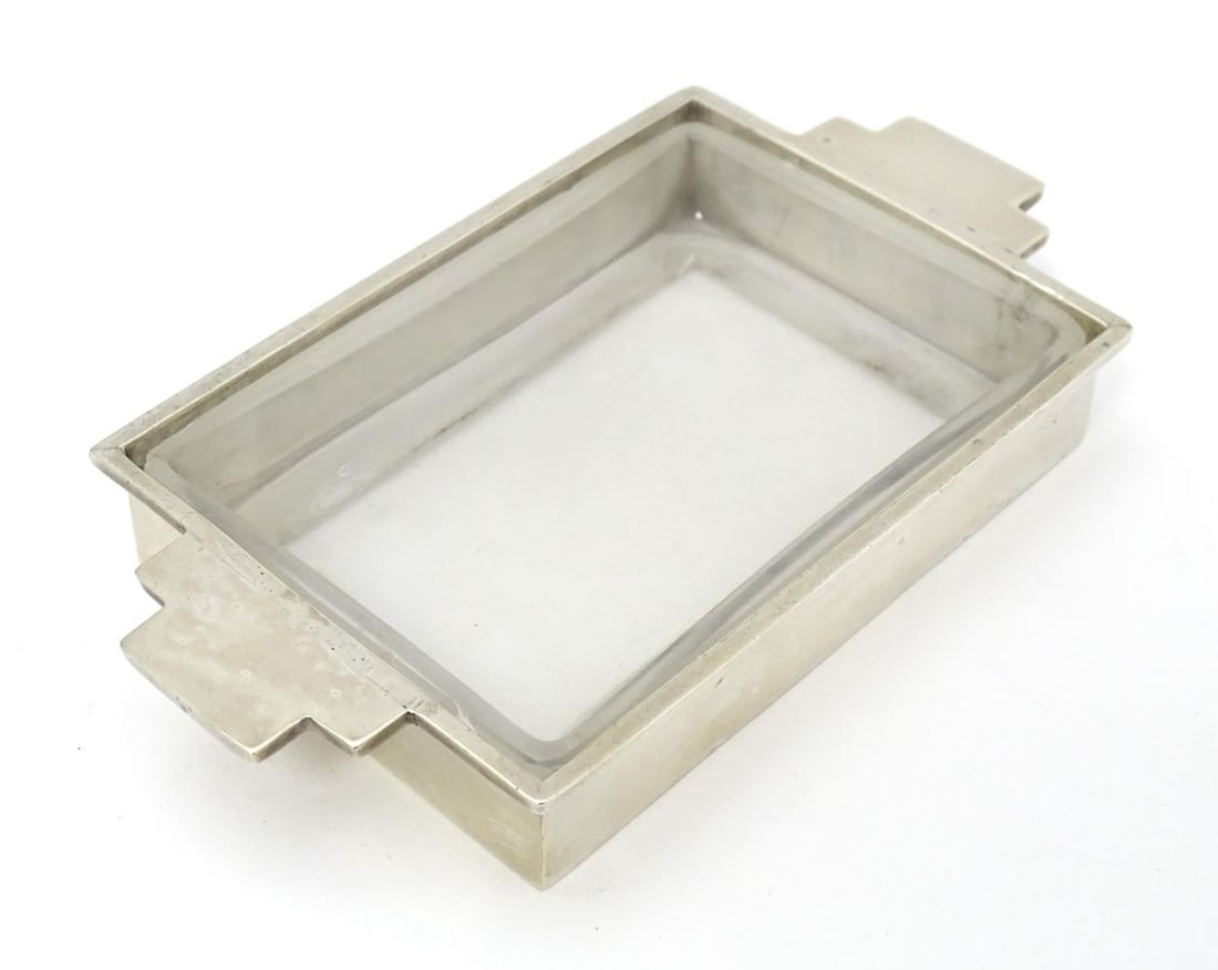 An Art Deco silver butter dish with glass liner. Hallmarked Sheffield 1937 maker Walker & Hall. 5": An Art Deco silver butter dish with glass liner. Hallmarked Sheffield 1937 maker Walker & Hall. 5" widePlease Note - we do not make reference to the condition of lots within descriptions. We are howev