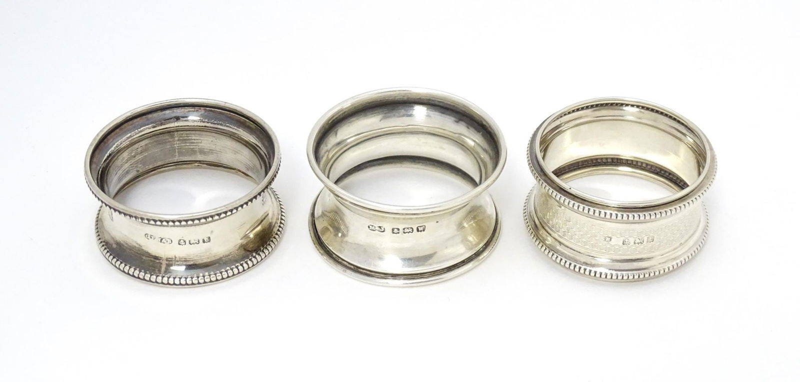 Three assorted napkin rings hallmarked Birmingham 1921, 1910 and 1918 (3) Please Note - we do not (1 of 7)